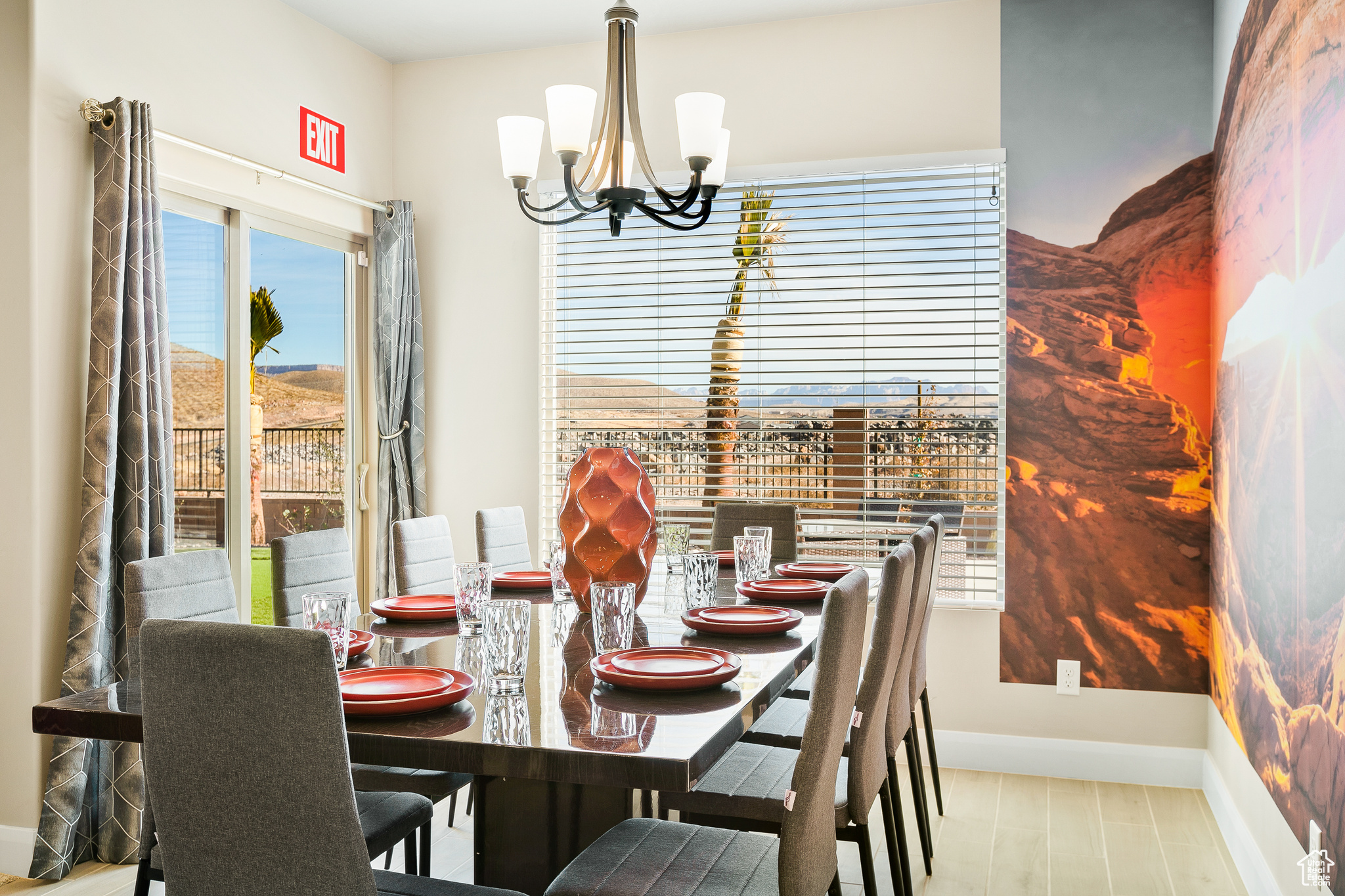 Dining space with light hardwood / wood-style floors and a notable chandelier