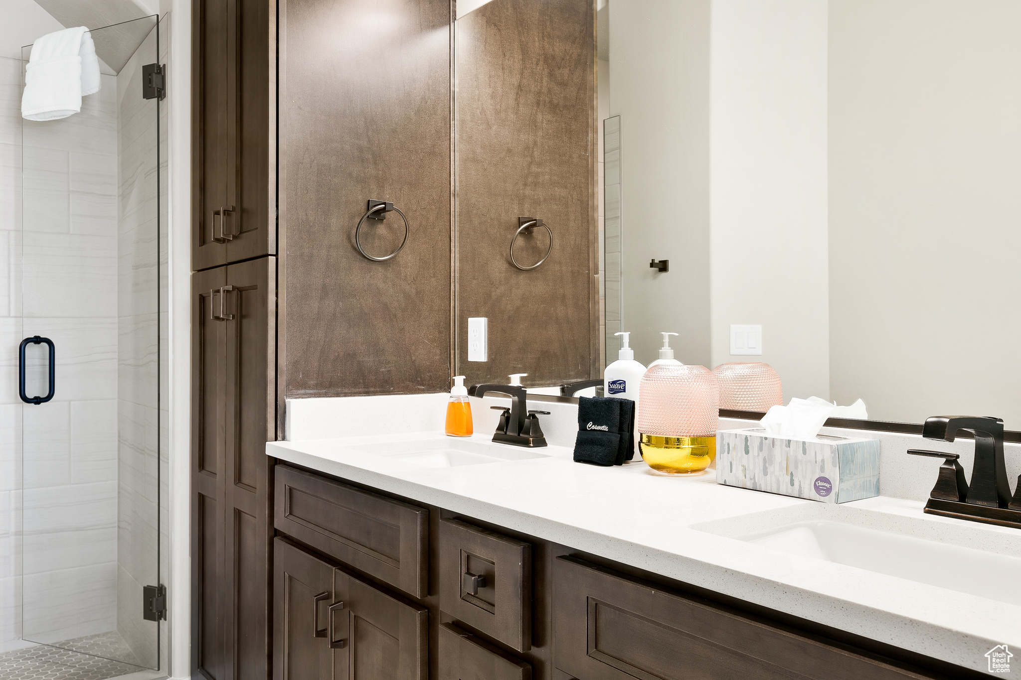 Bathroom featuring vanity and a shower with door