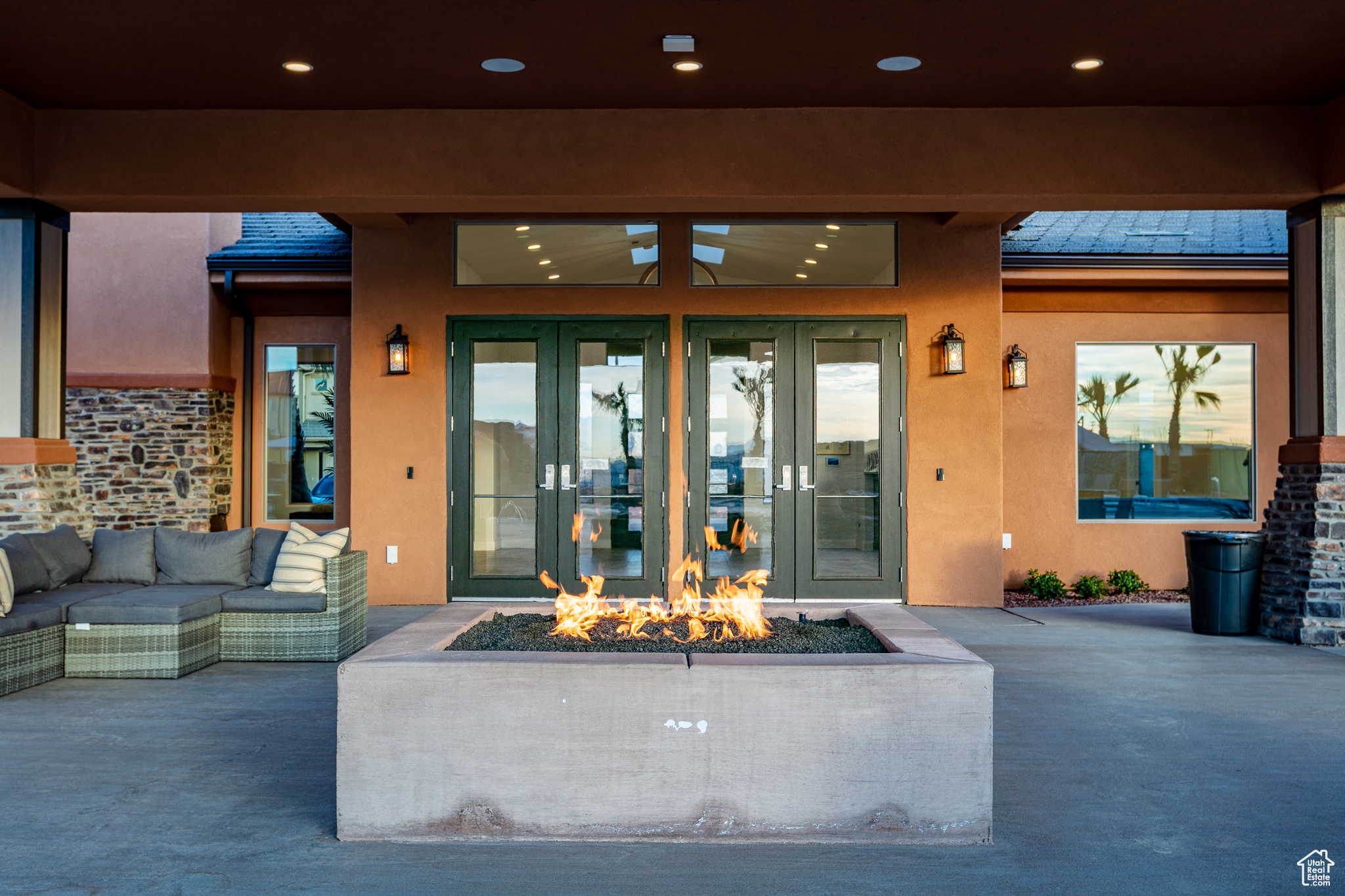 Property entrance with a patio, french doors, ceiling fan, and an outdoor hangout area