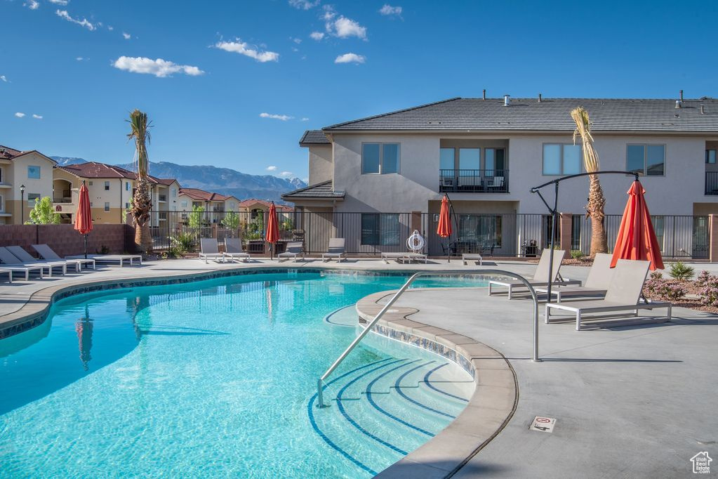 View of swimming pool featuring a mountain view and a patio