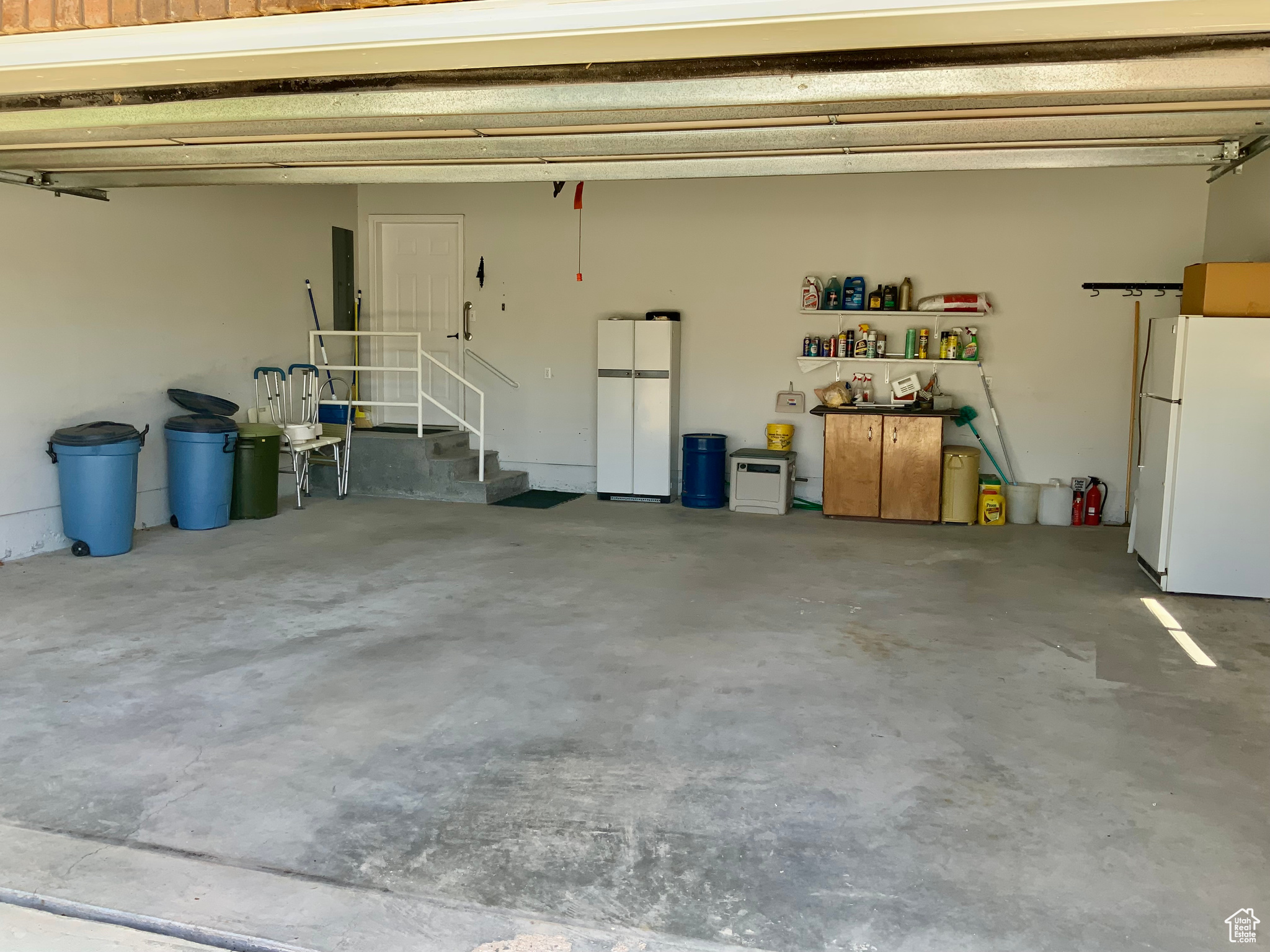 Garage with white fridge