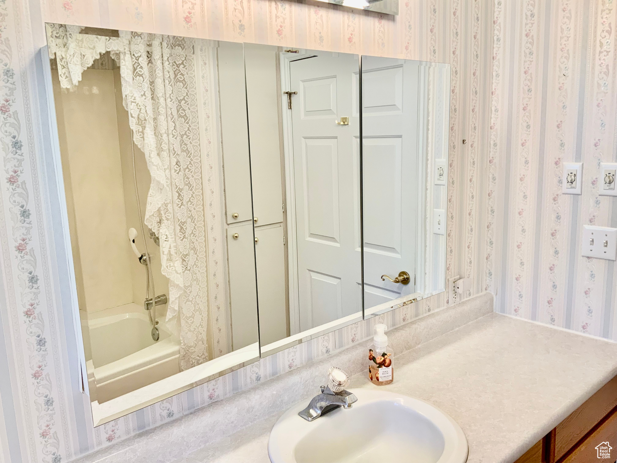 Bathroom featuring vanity and shower / bath combination
