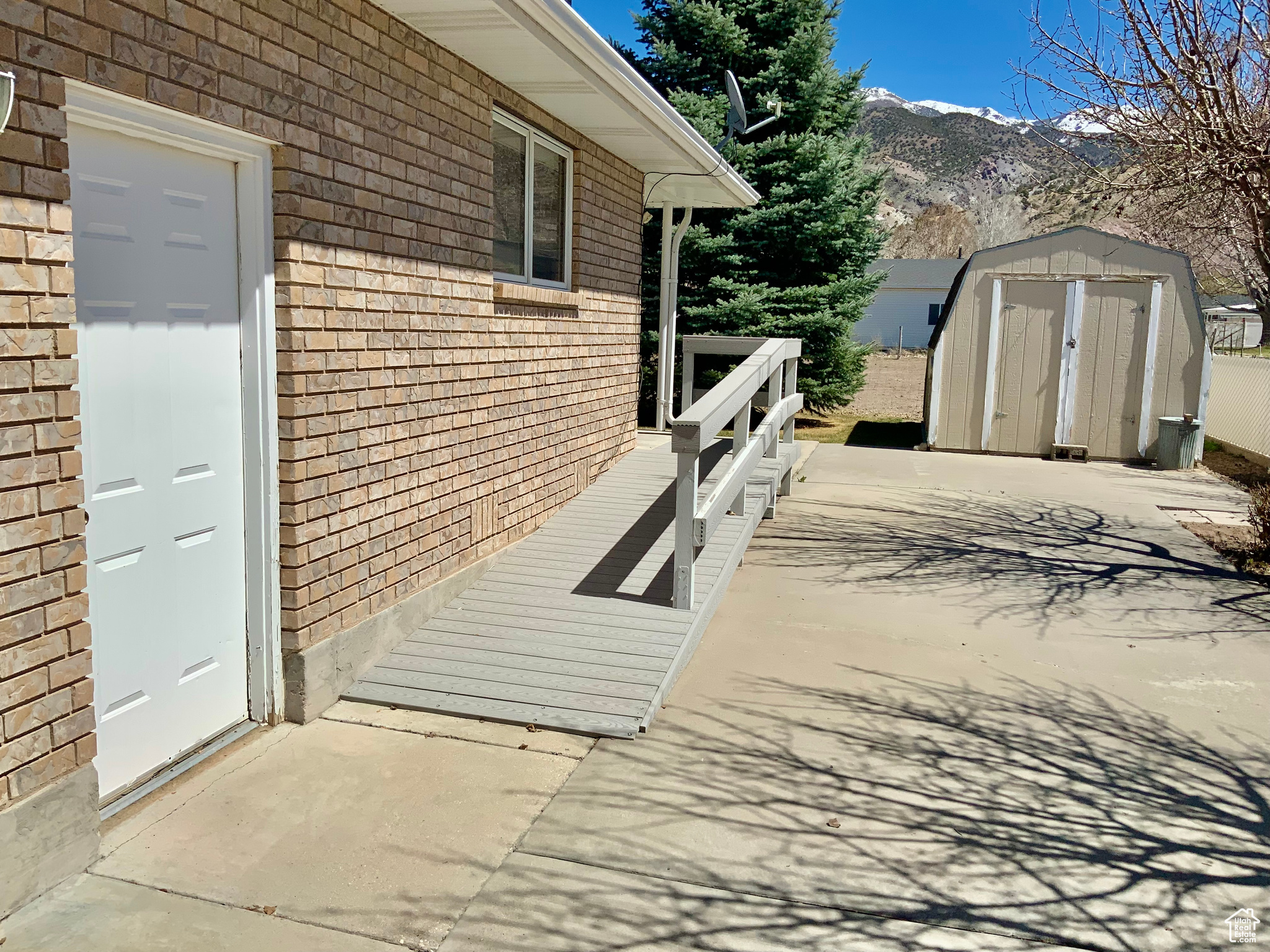 Exterior space featuring a storage unit and a mountain view