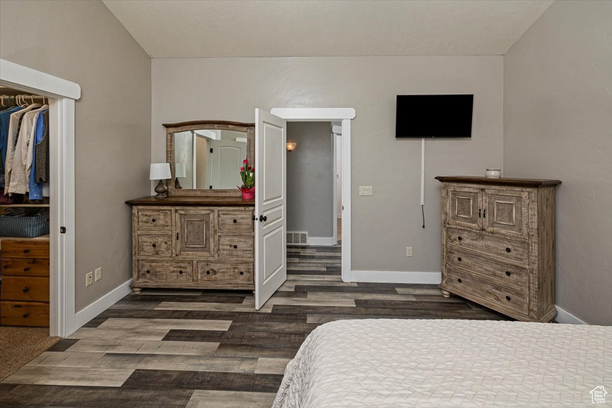 Bedroom with dark hardwood / wood-style floors