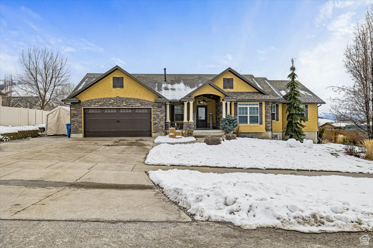View of front of property with a garage, concrete driveway, RV parking and fence