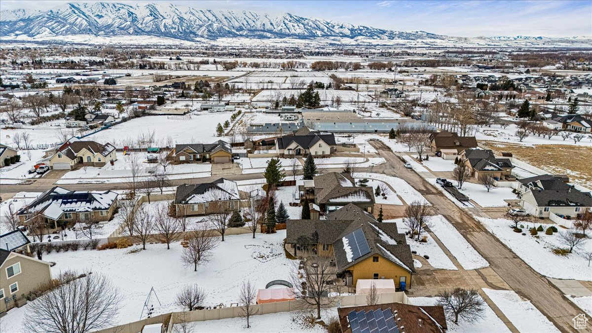 Snowy aerial  backyard view with a mountain view