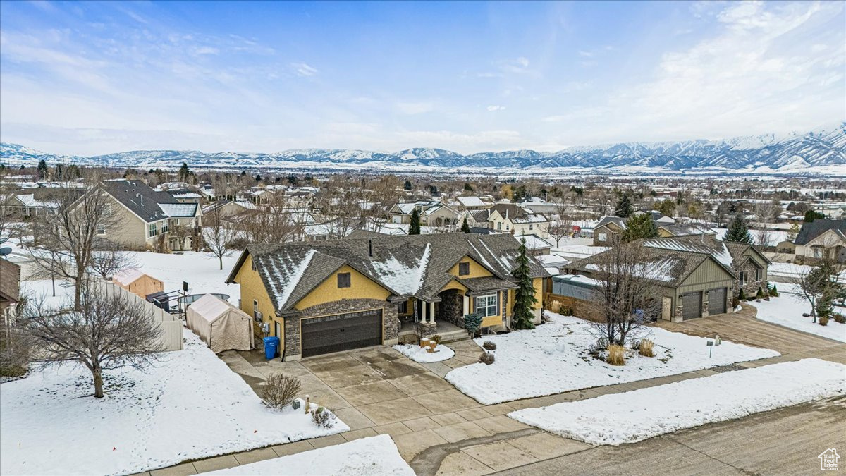 Snowy aerial view with a residential view and a mountain view