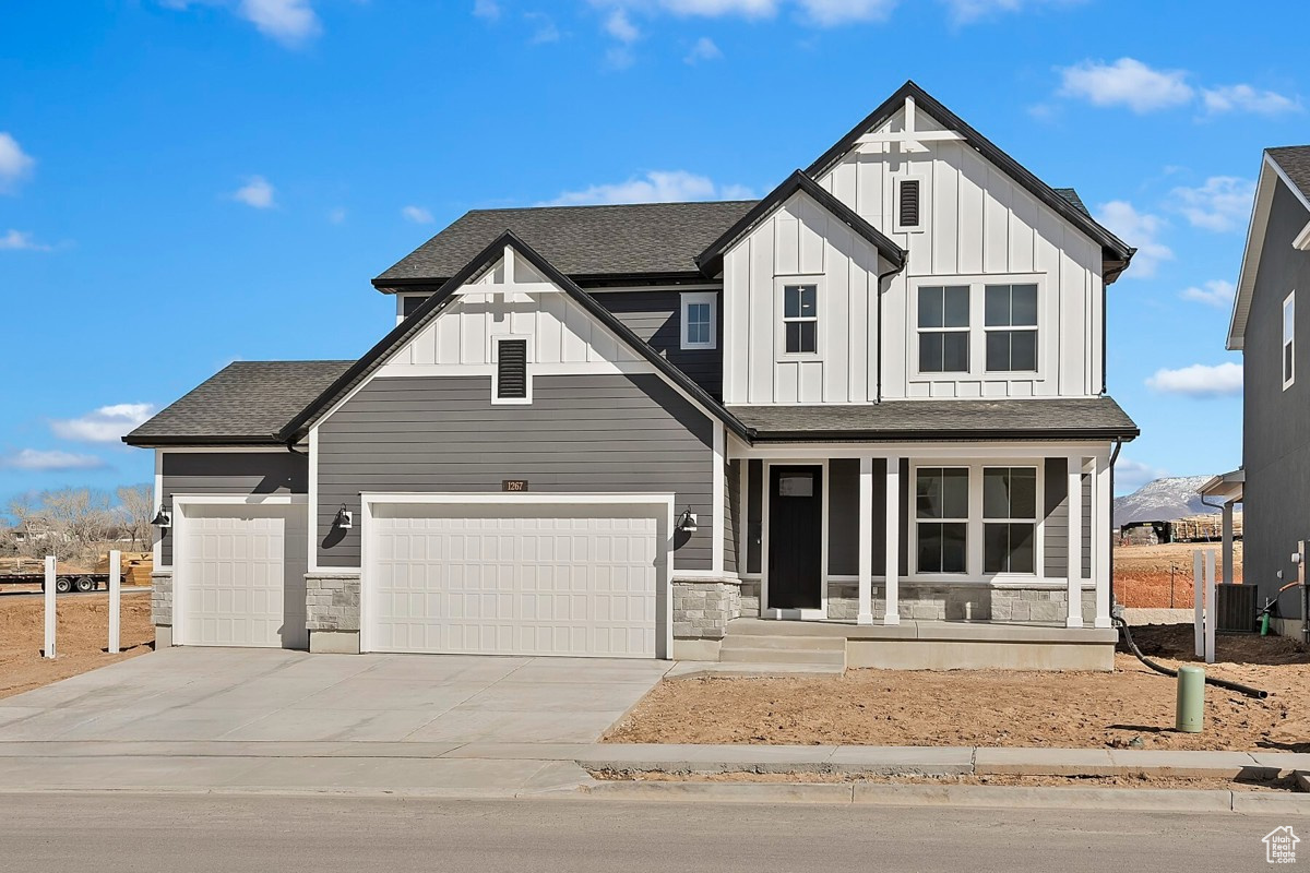 Charming and timeless Craftsman with extended covered porch and 3-car garage.