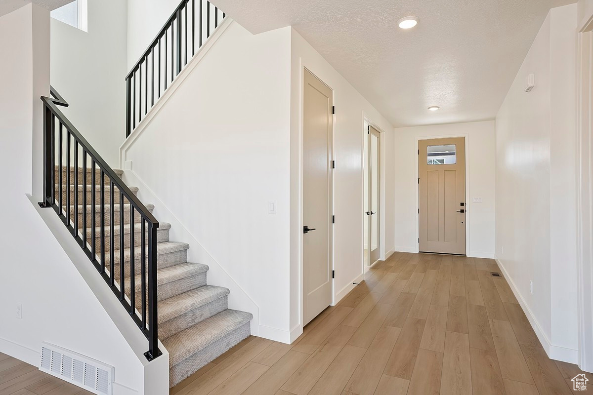 Spacious entry with home office featuring French doors.