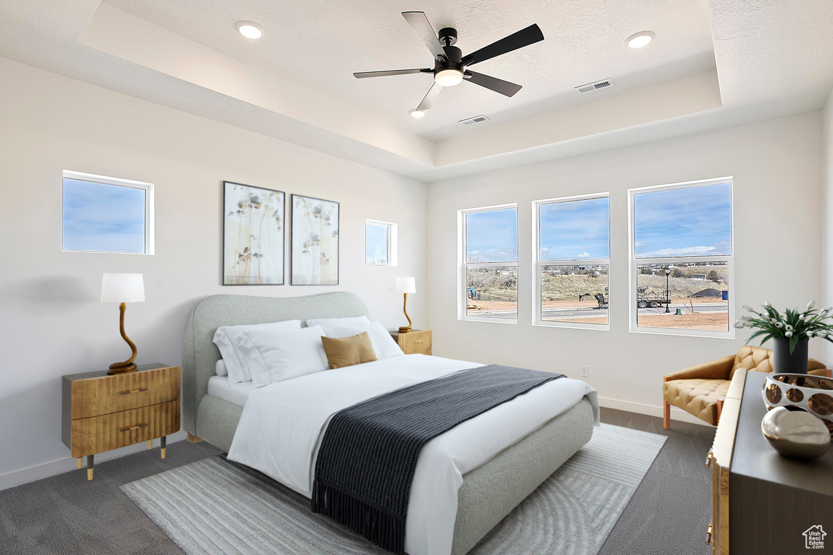 Primary Bedroom with trey ceiling, oversized windows, and ceiling fan.