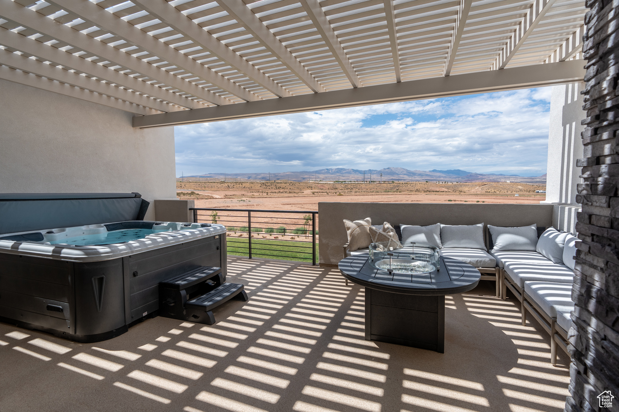 View of patio / terrace with a hot tub, an outdoor living space, a mountain view, and a pergola