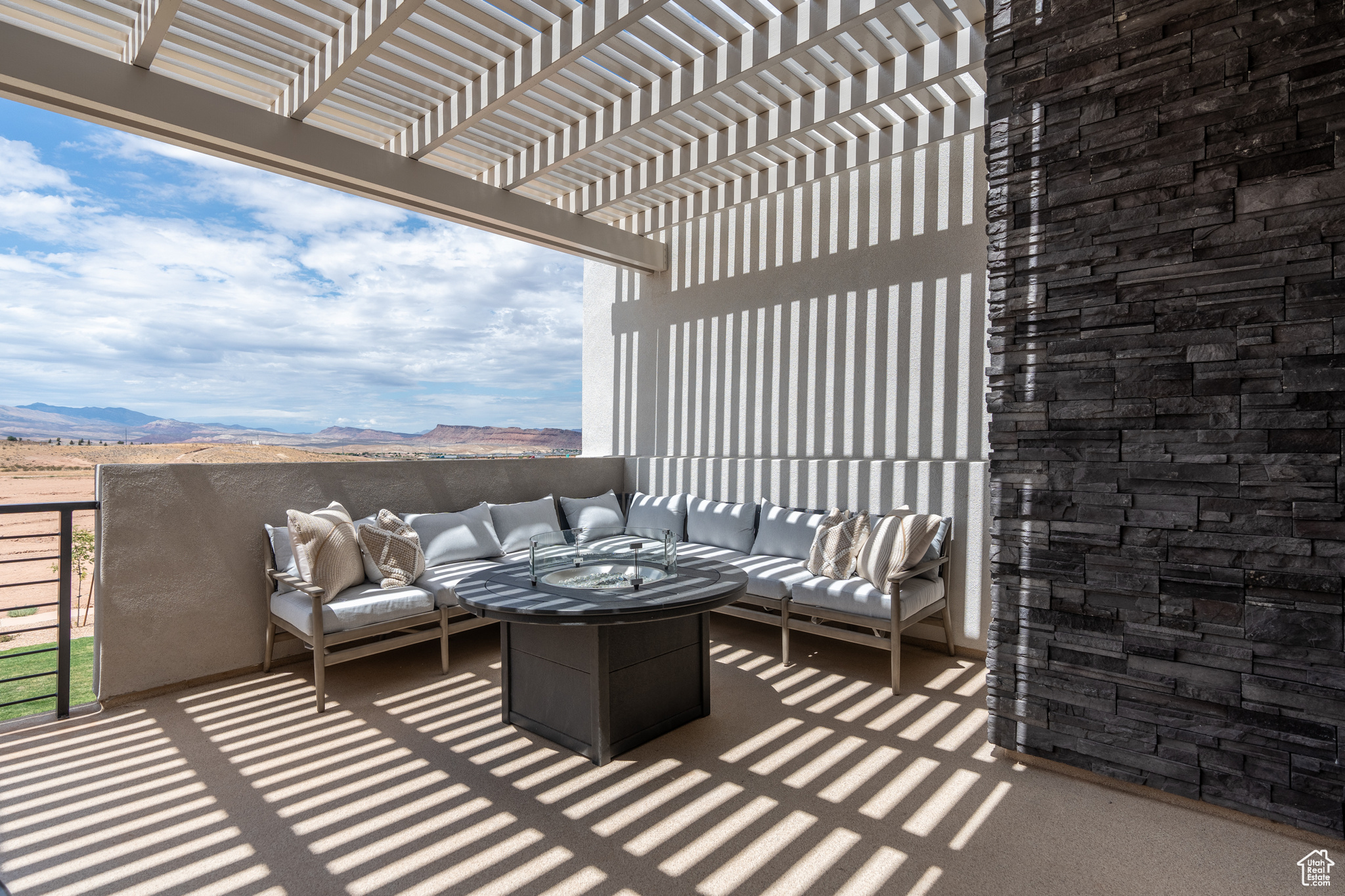 Balcony with a pergola, an outdoor living space with a fire pit, and a mountain view