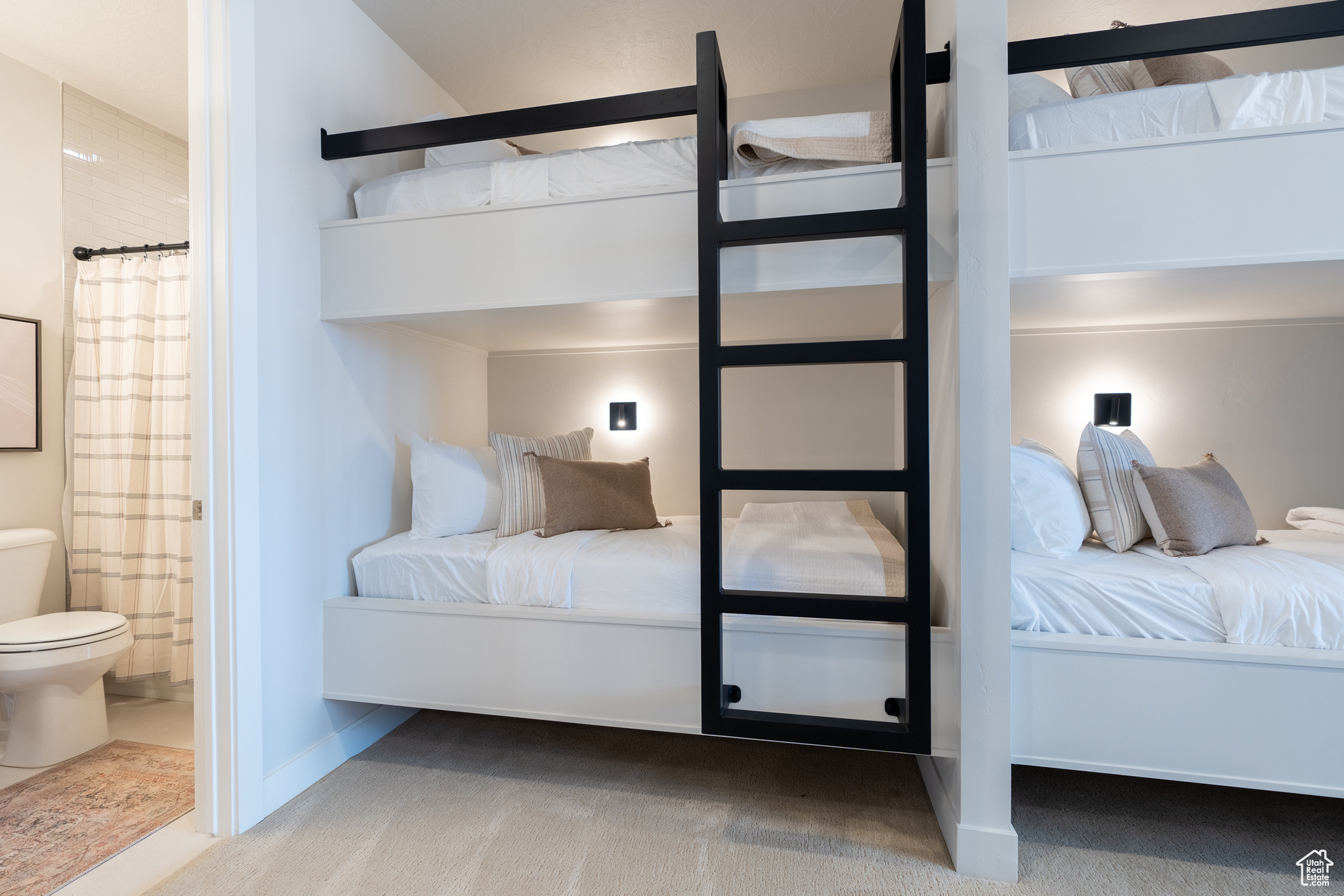 Unfurnished bedroom featuring ensuite bath and carpet flooring