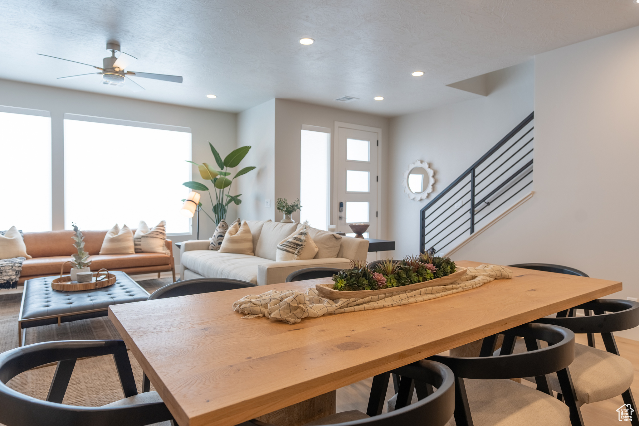 Living room with hardwood / wood-style floors and ceiling fan