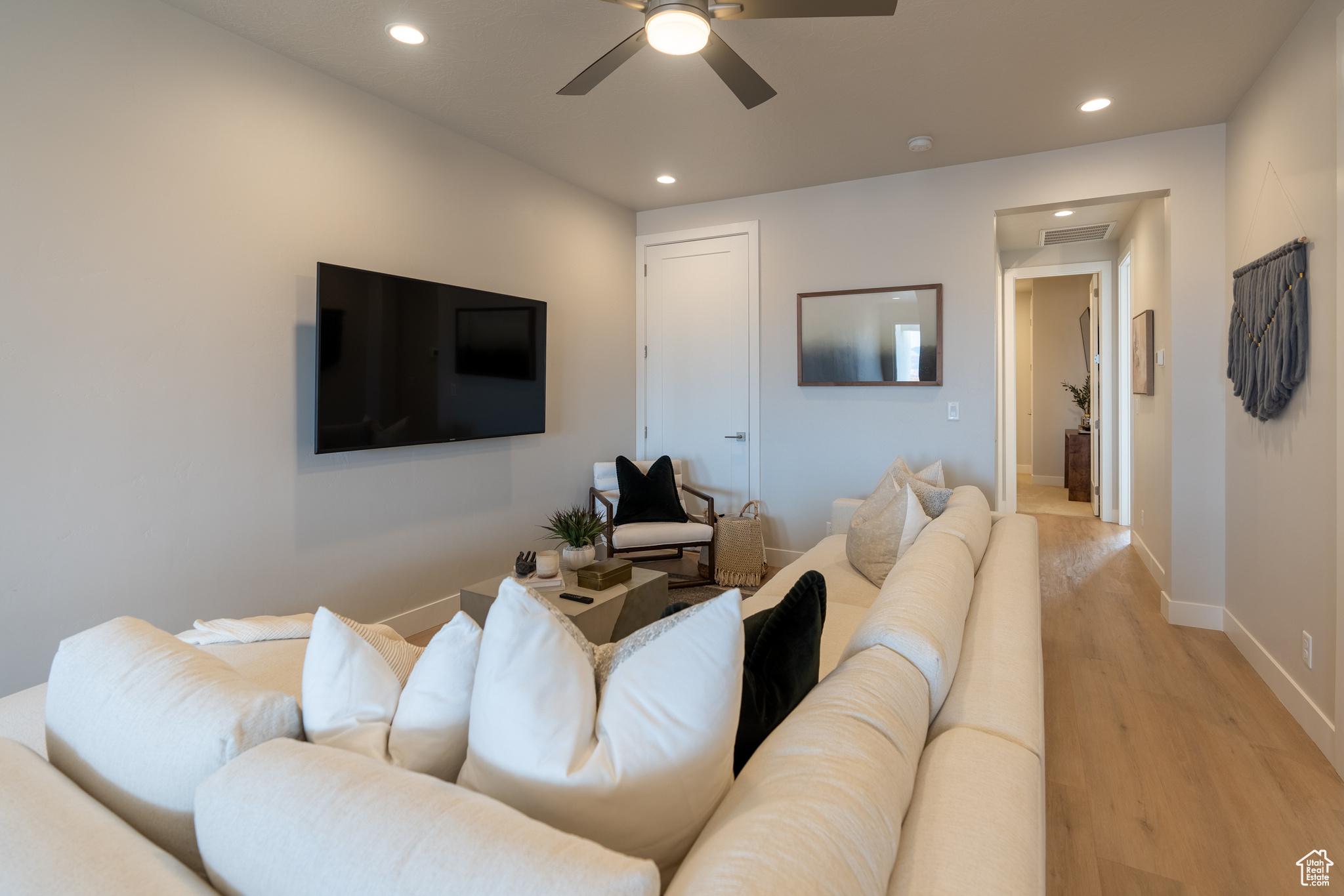 Living room featuring light hardwood / wood-style flooring and ceiling fan