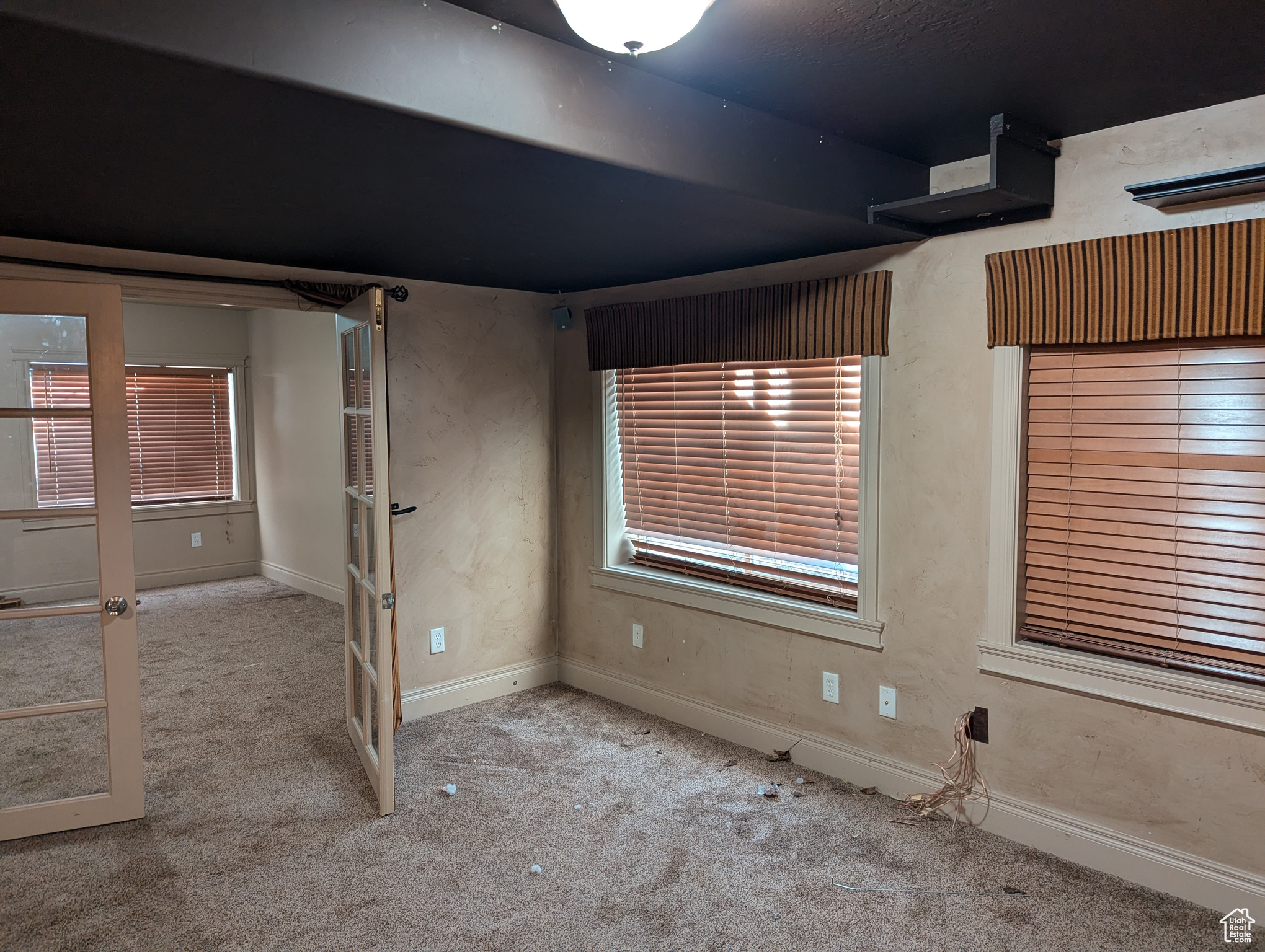 Unfurnished room featuring light carpet