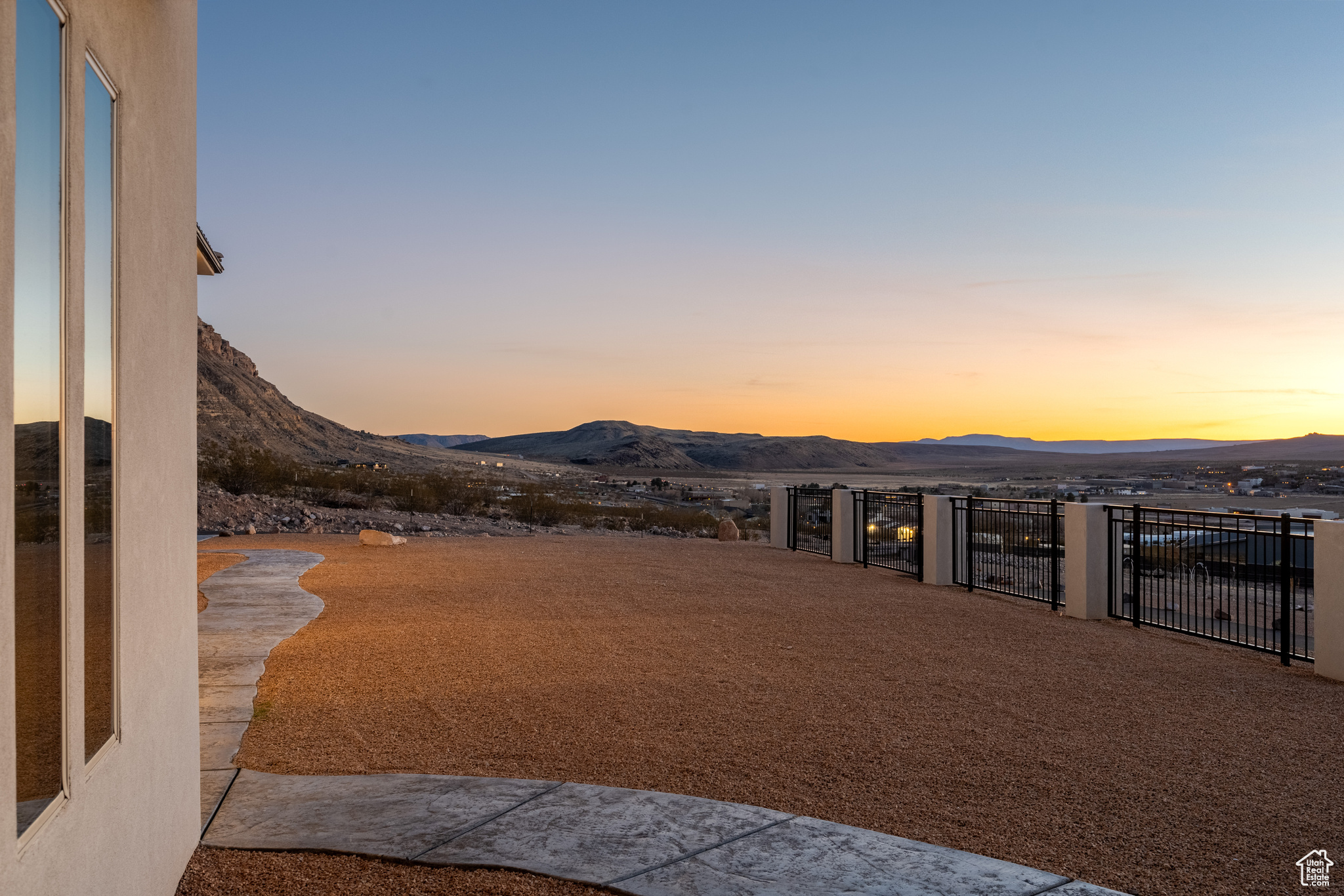 View of yard featuring a gate, a mountain view, and fence