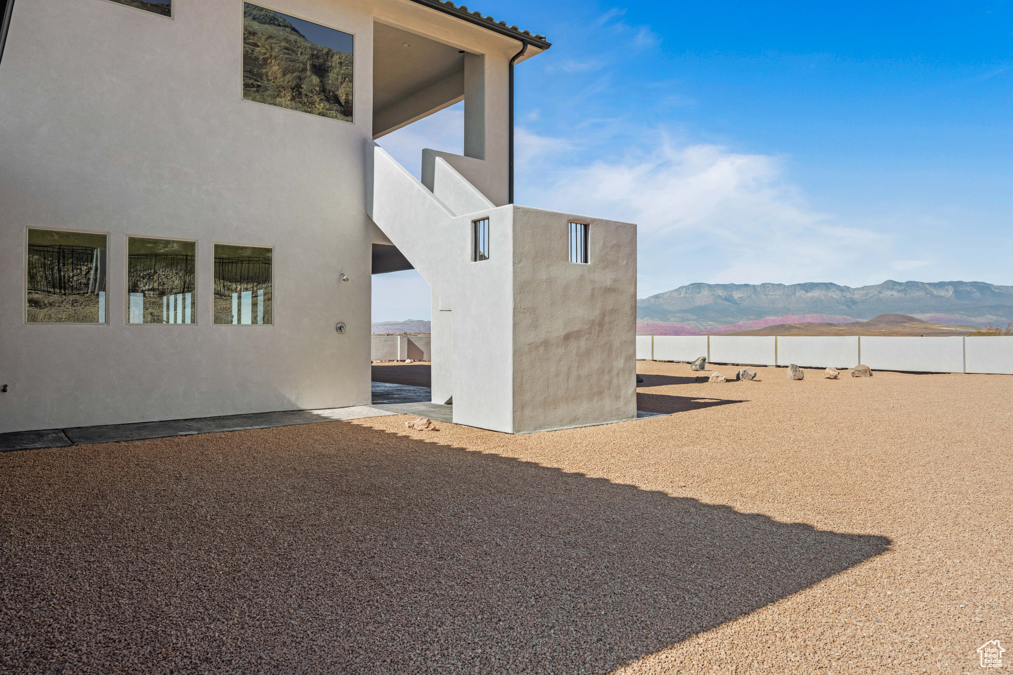 View of side of home with a mountain view