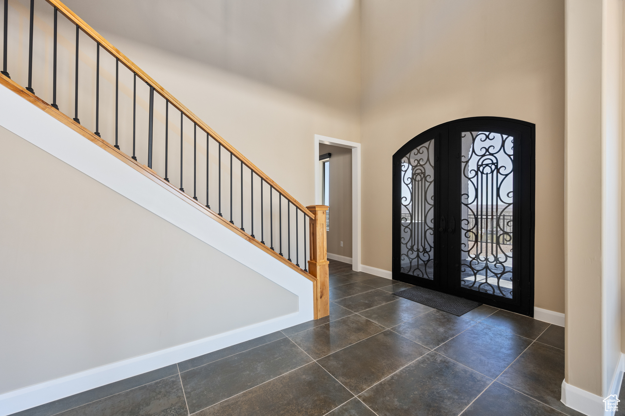 Entryway featuring french doors and a towering ceiling