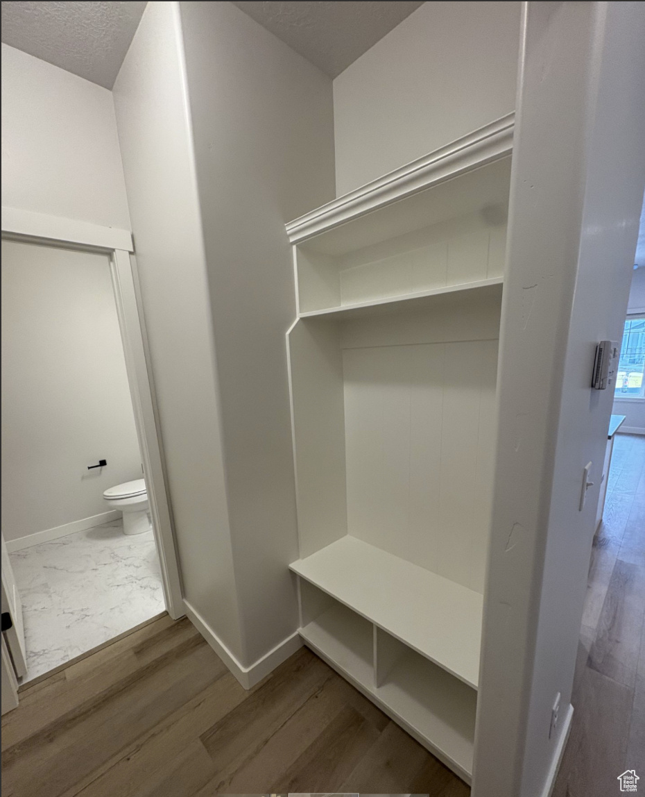 Mudroom featuring hardwood / wood-style flooring and a textured ceiling