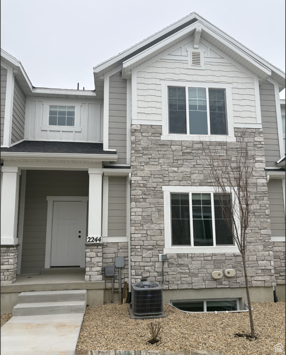 View of front of property with cooling unit