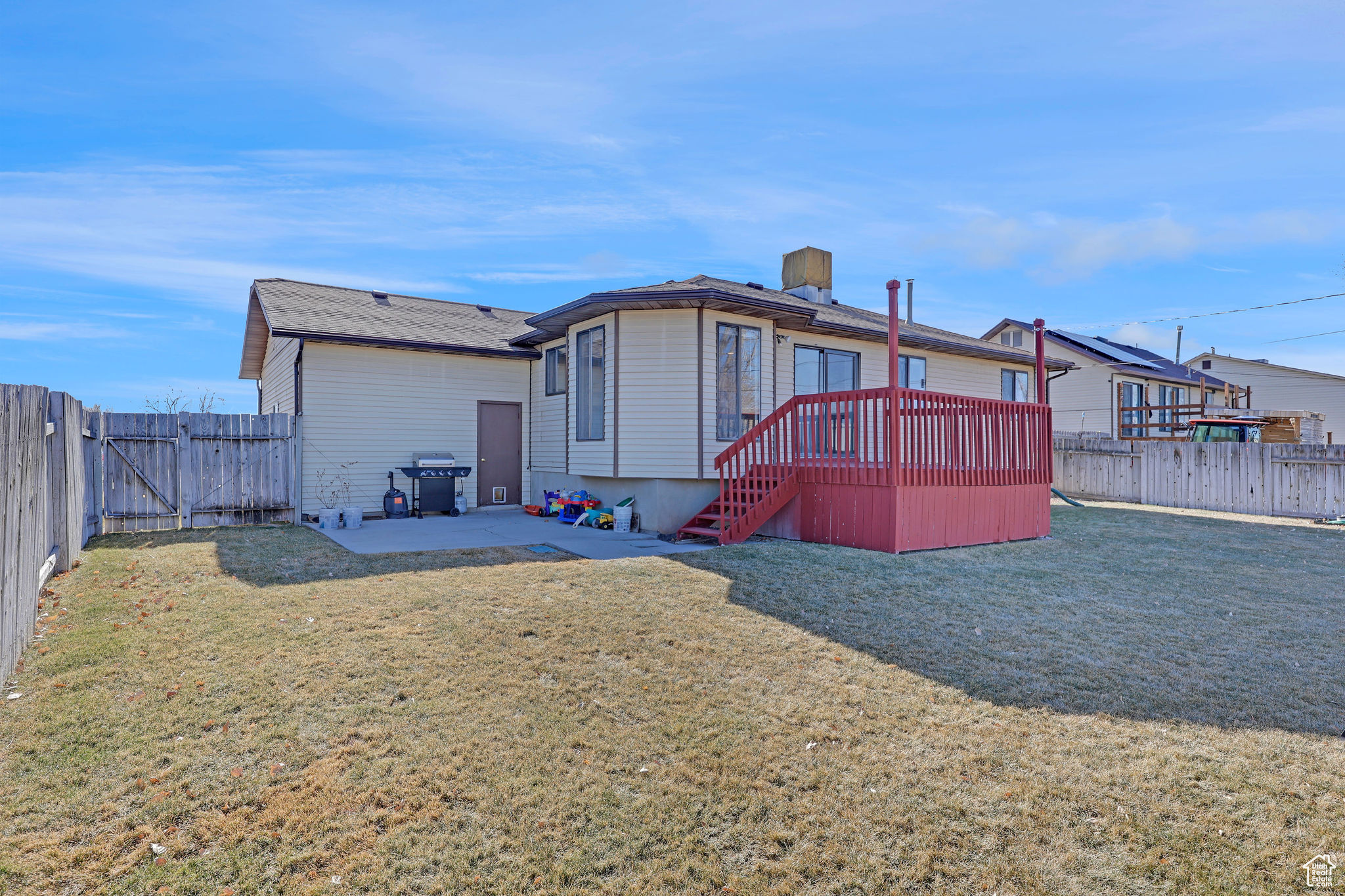 Back of house featuring a patio area, a yard, and a deck