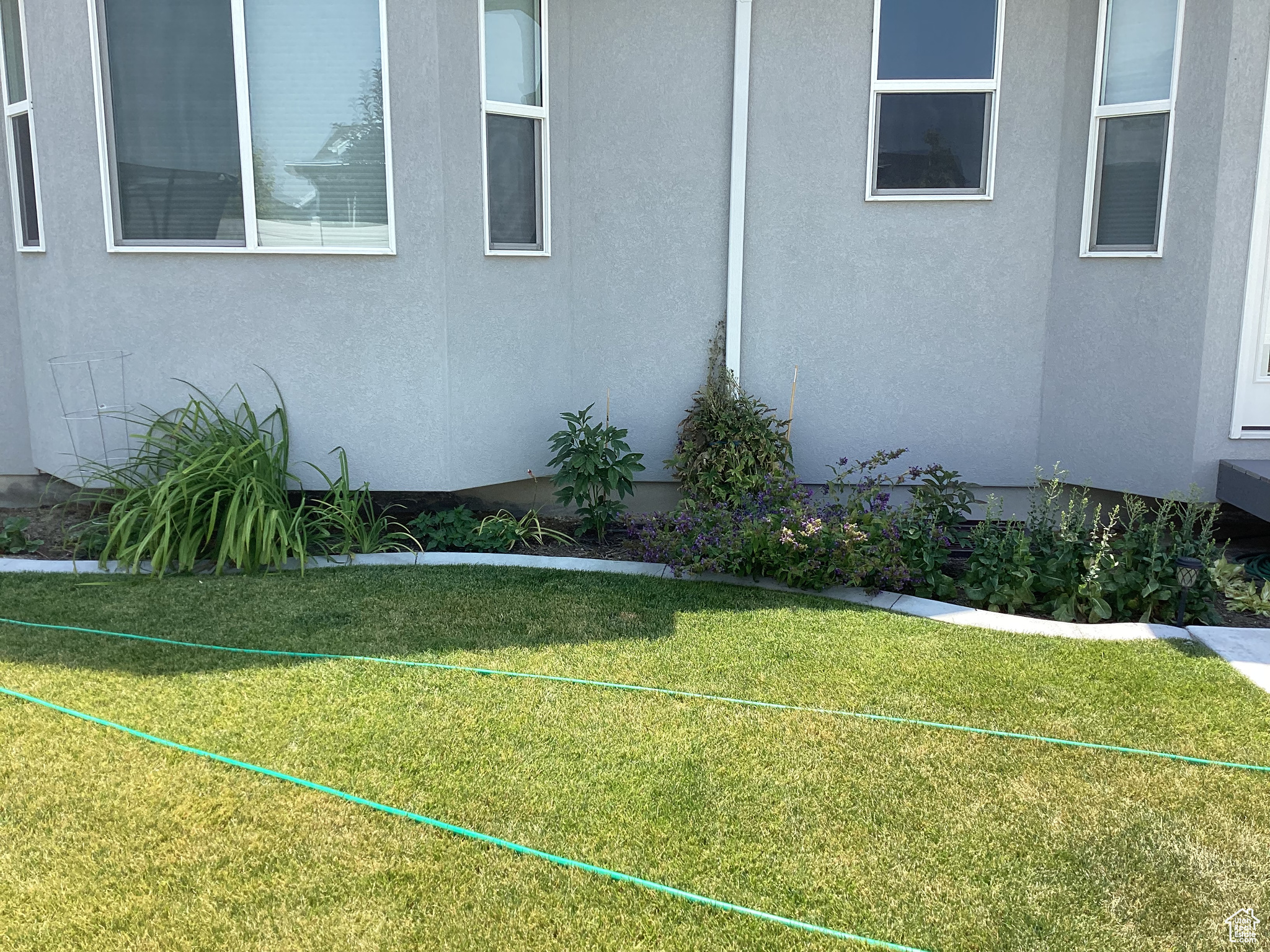 View of property exterior with a yard