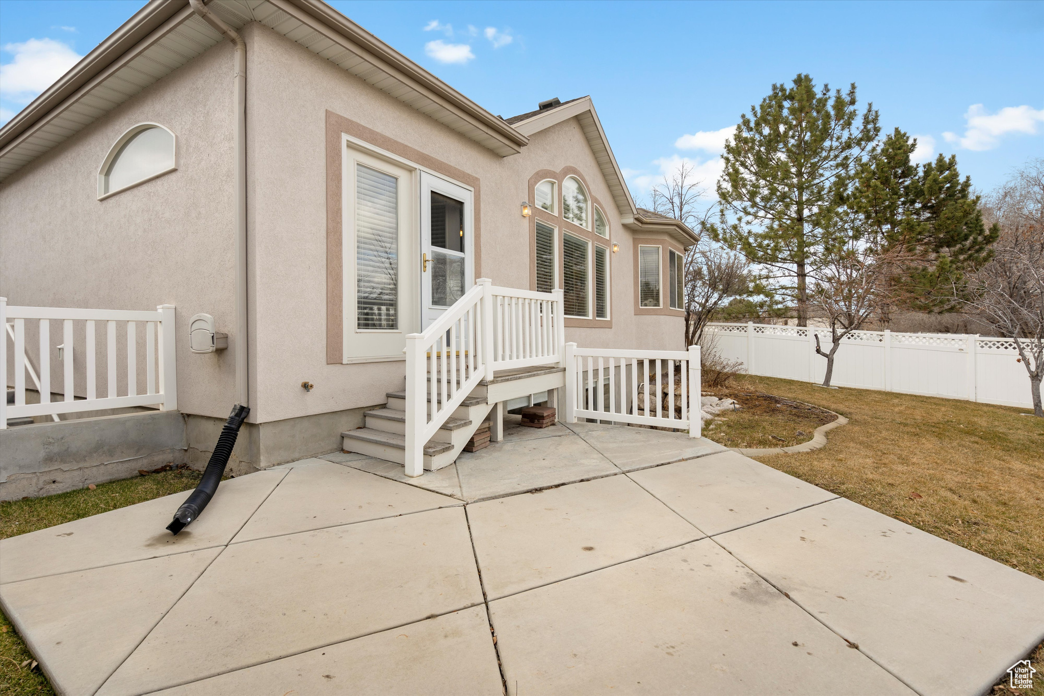 Rear view of property with a patio area and a lawn