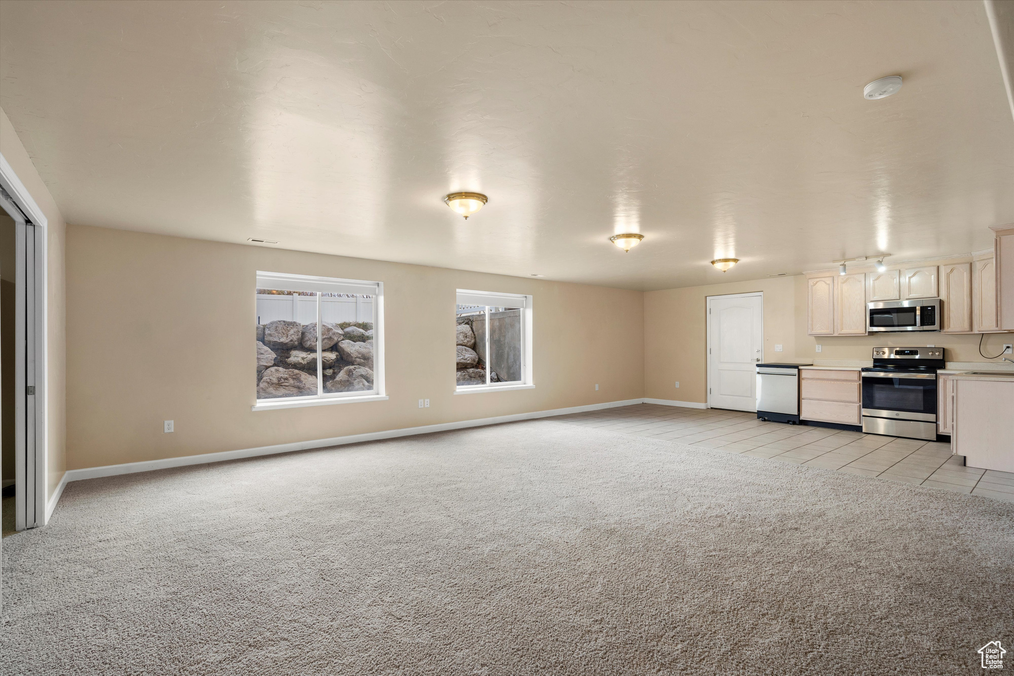 Unfurnished living room with light colored carpet