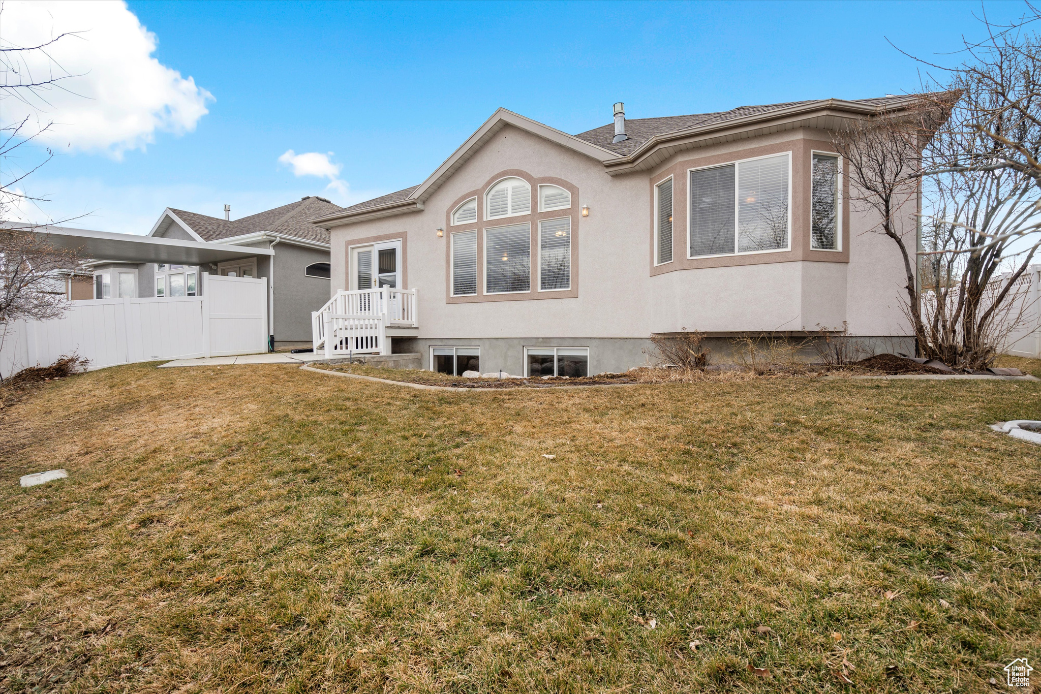 Rear view of house with a lawn
