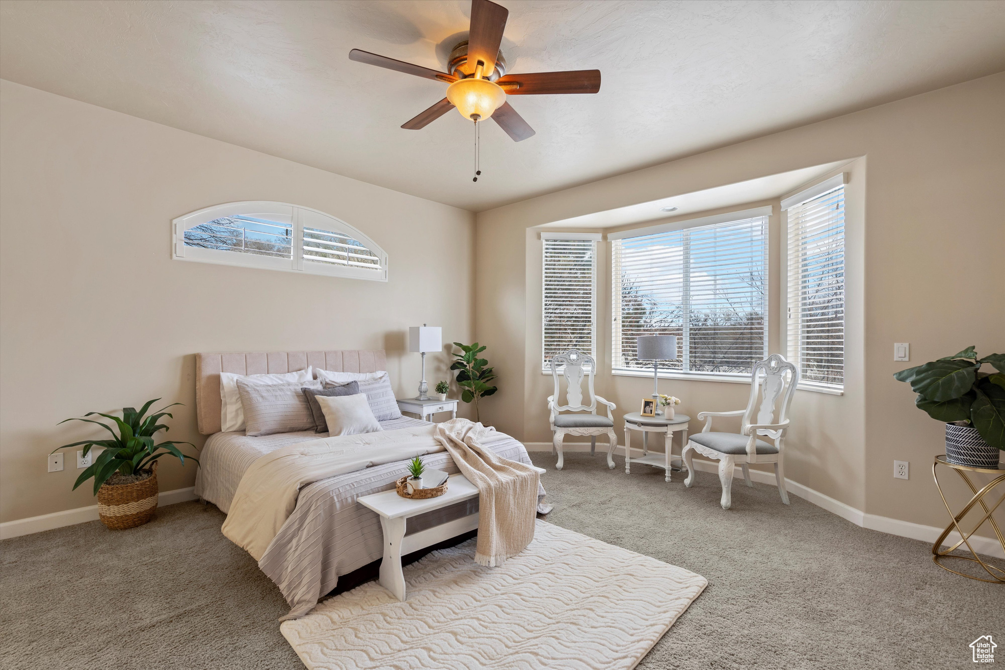 Carpeted bedroom featuring ceiling fan