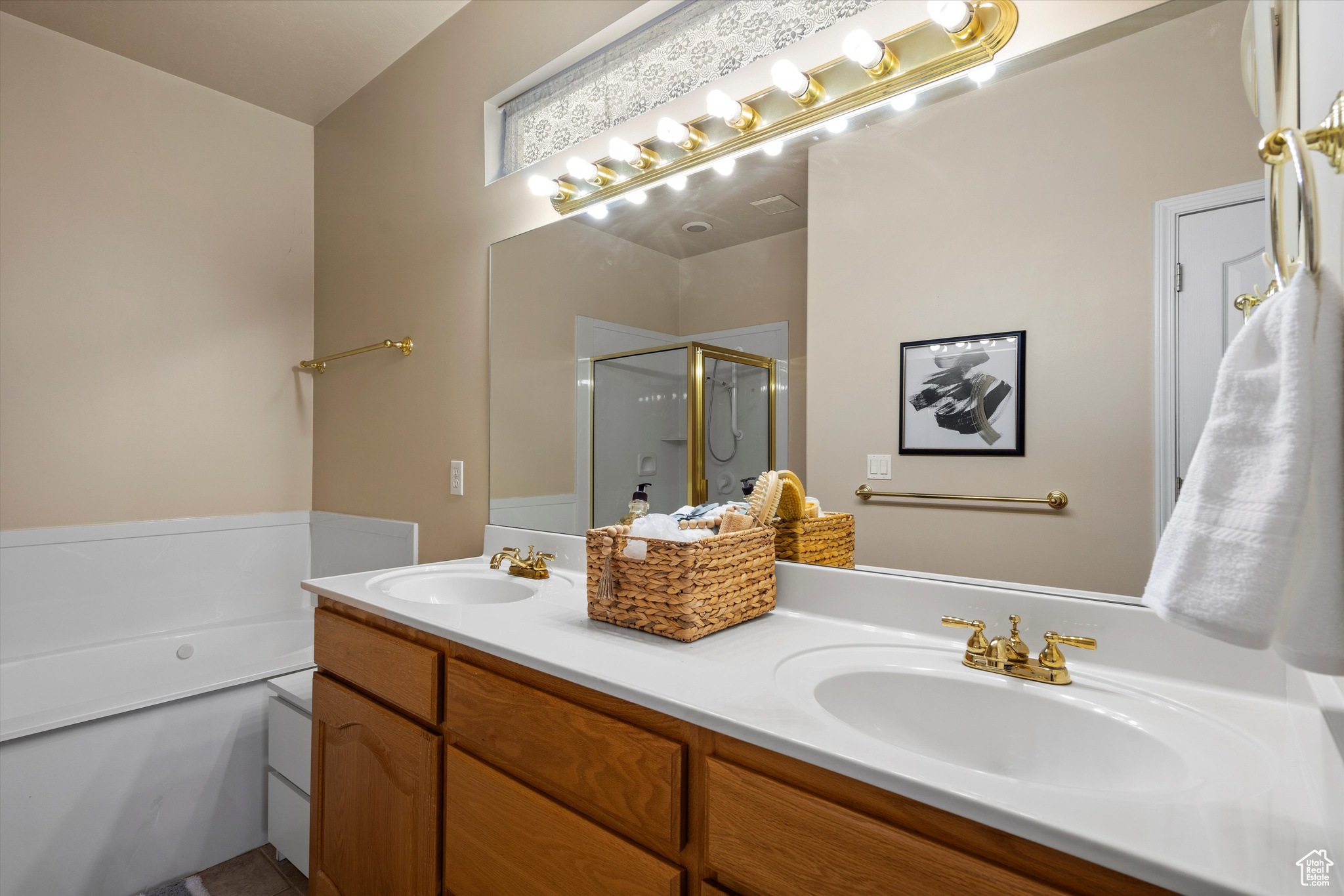 Bathroom featuring vanity and shower with separate bathtub