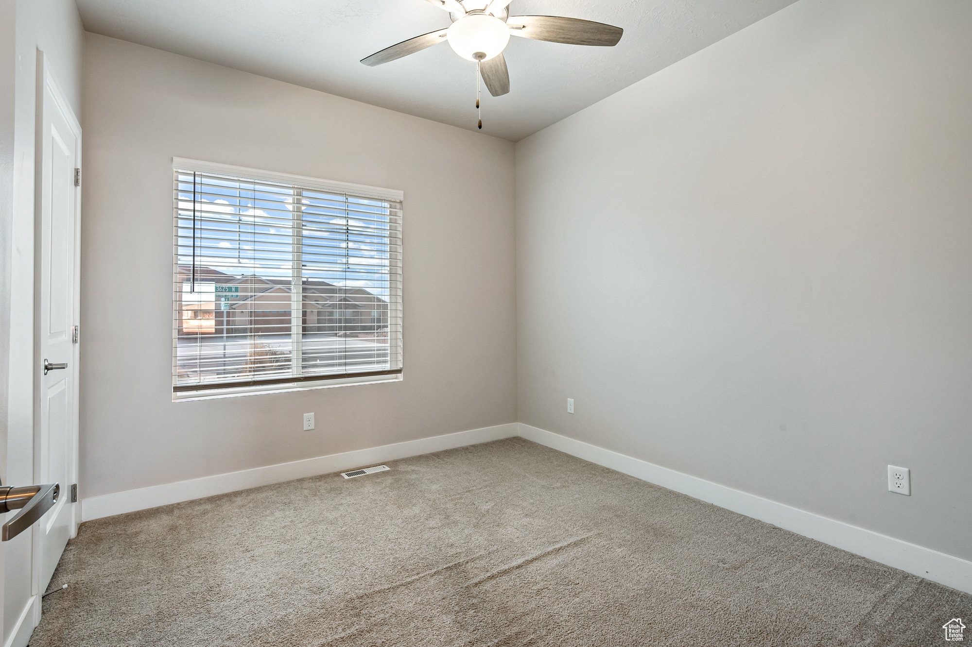 Spare room with ceiling fan and carpet floors