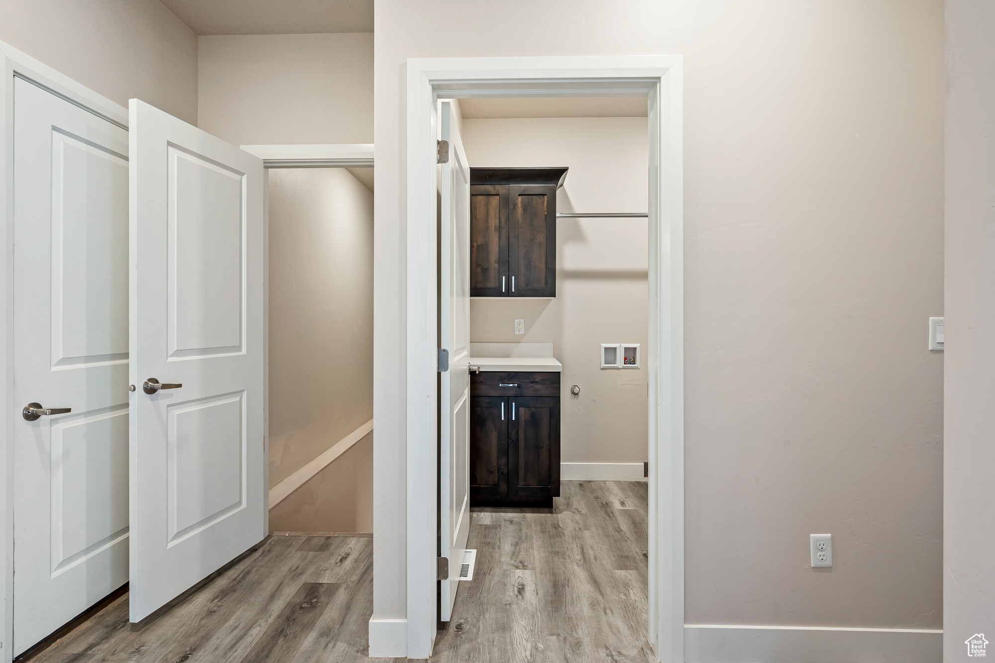 Corridor featuring light wood-type flooring