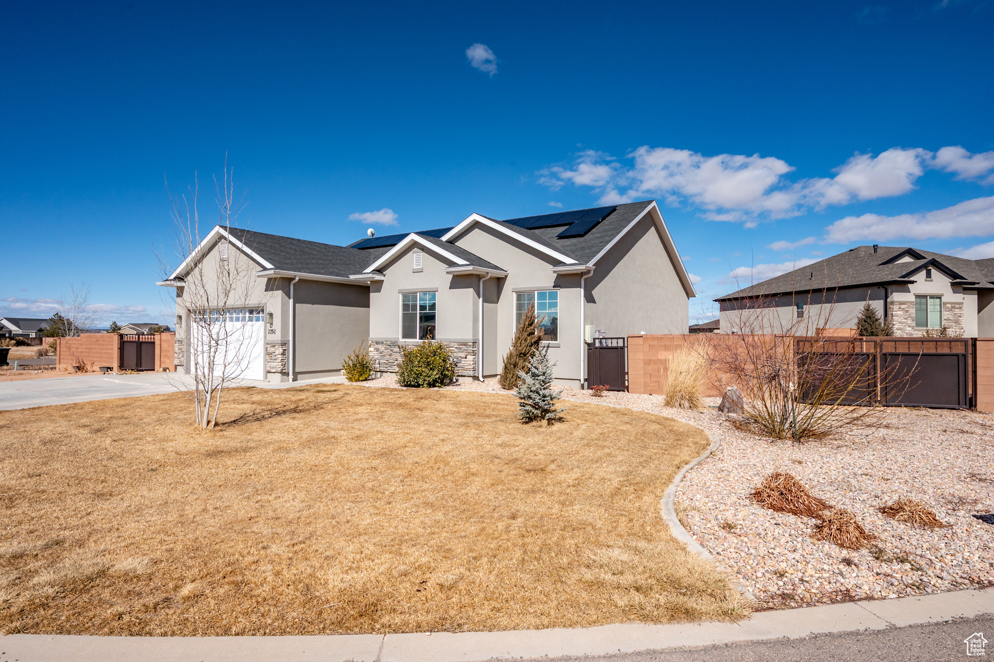 View of front of home featuring a garage and a front yard