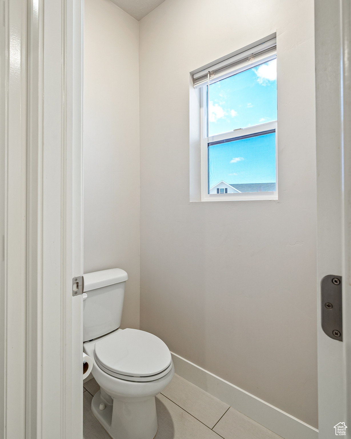 Bathroom featuring toilet and tile patterned flooring