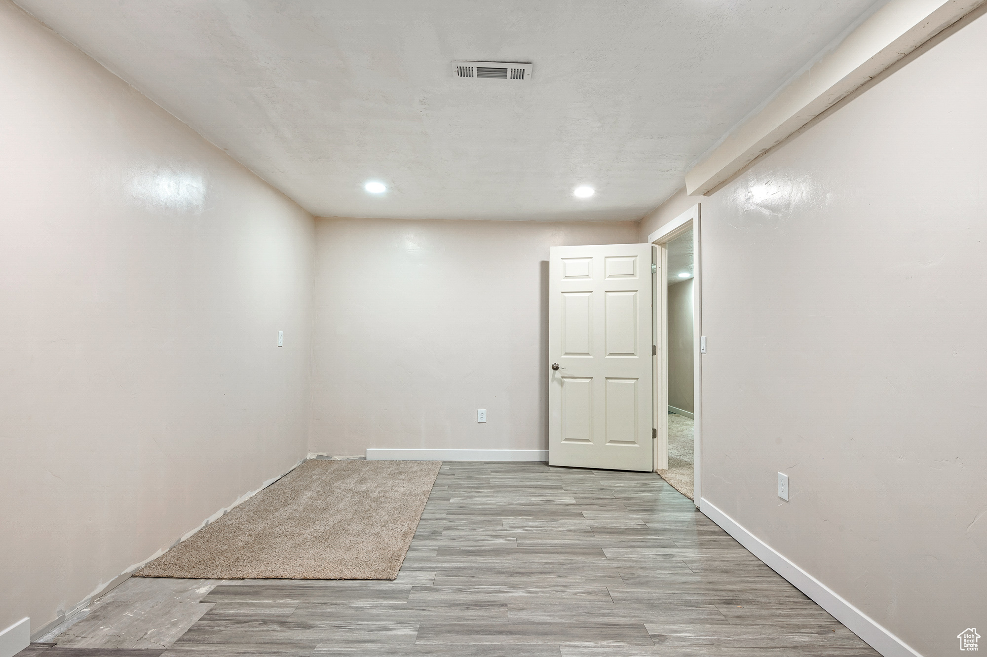 Unfurnished room with light hardwood / wood-style floors