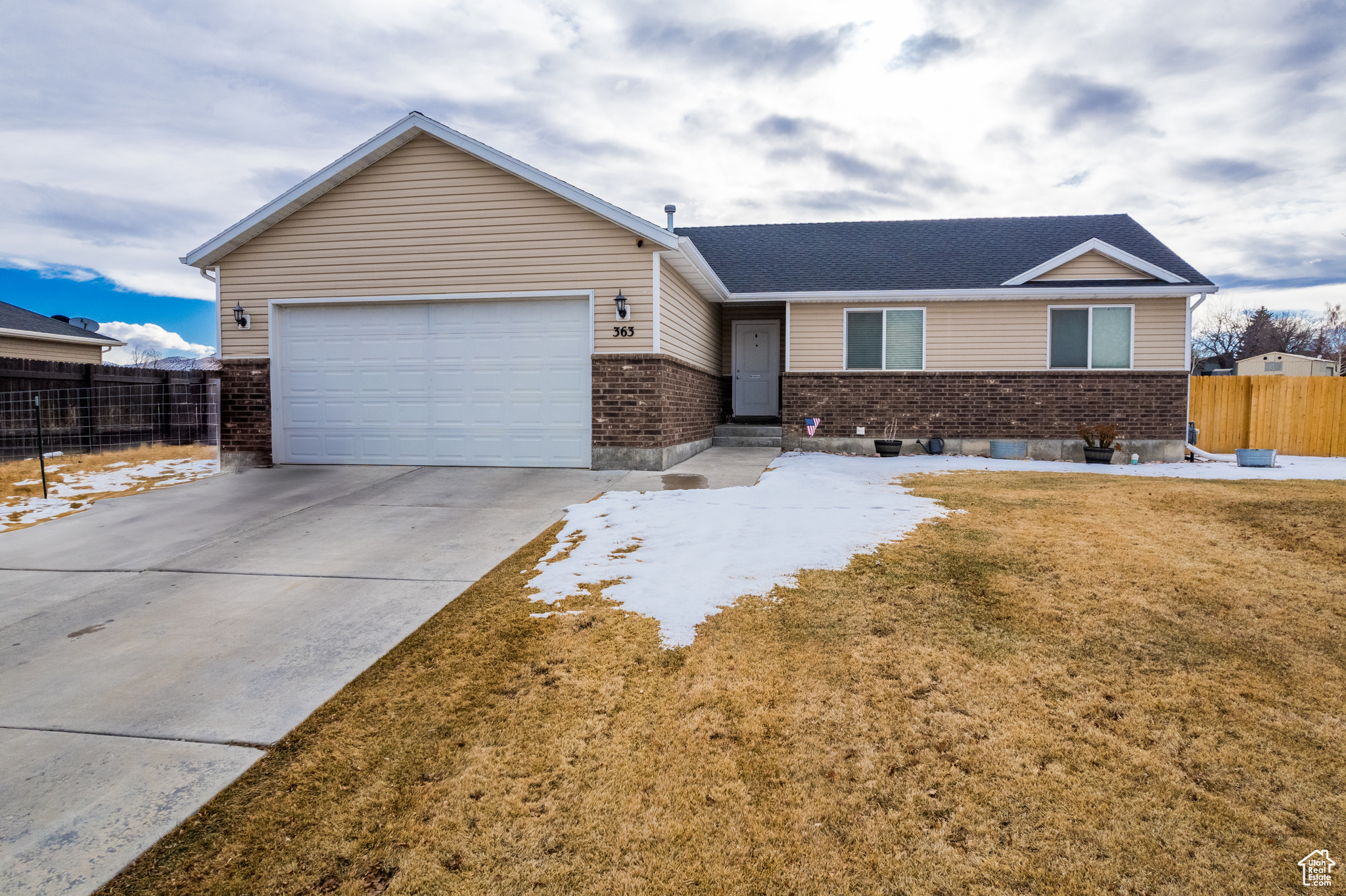 Ranch-style home featuring a garage and a front yard