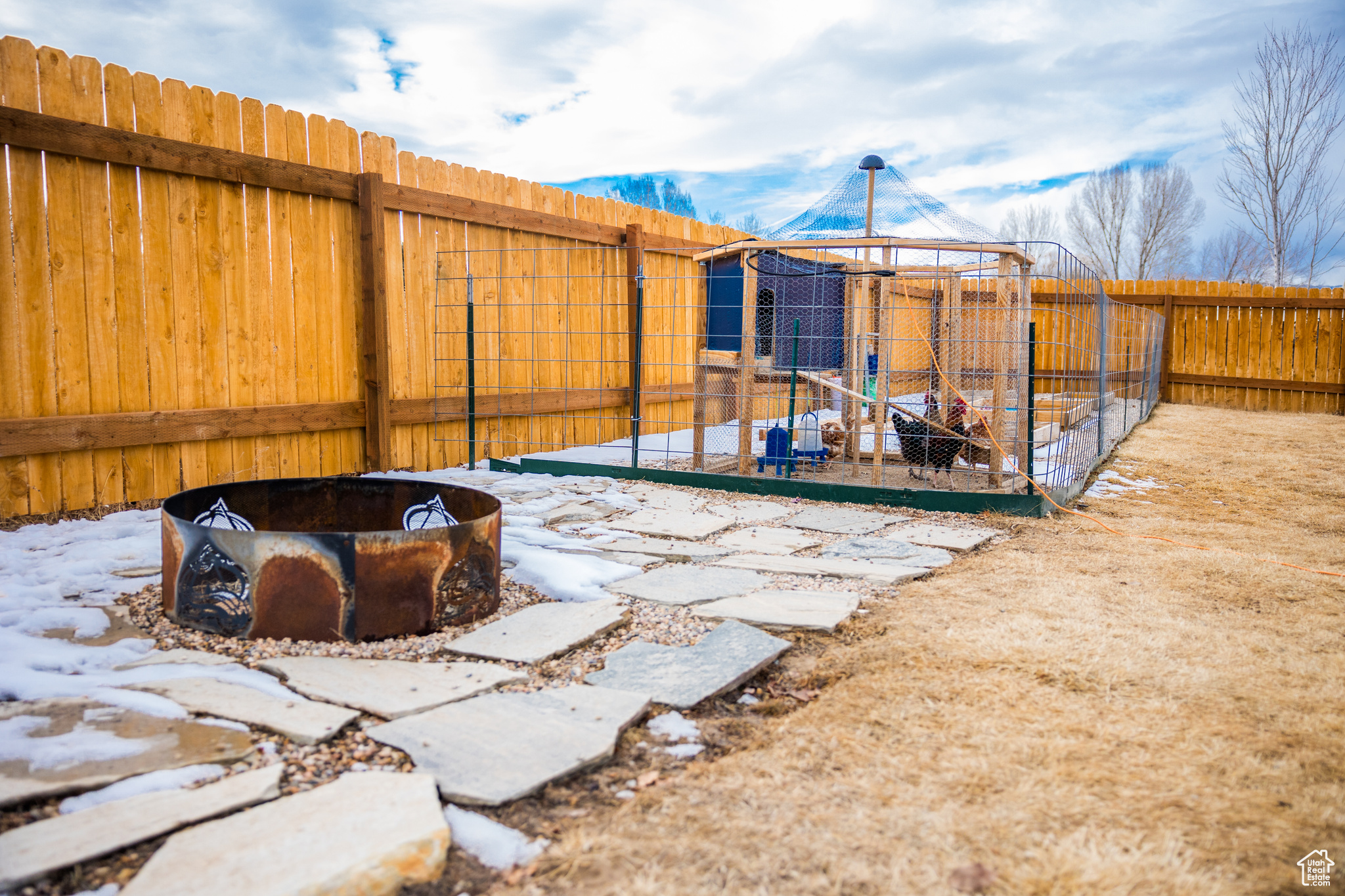 Snowy yard featuring an outdoor fire pit and a gazebo