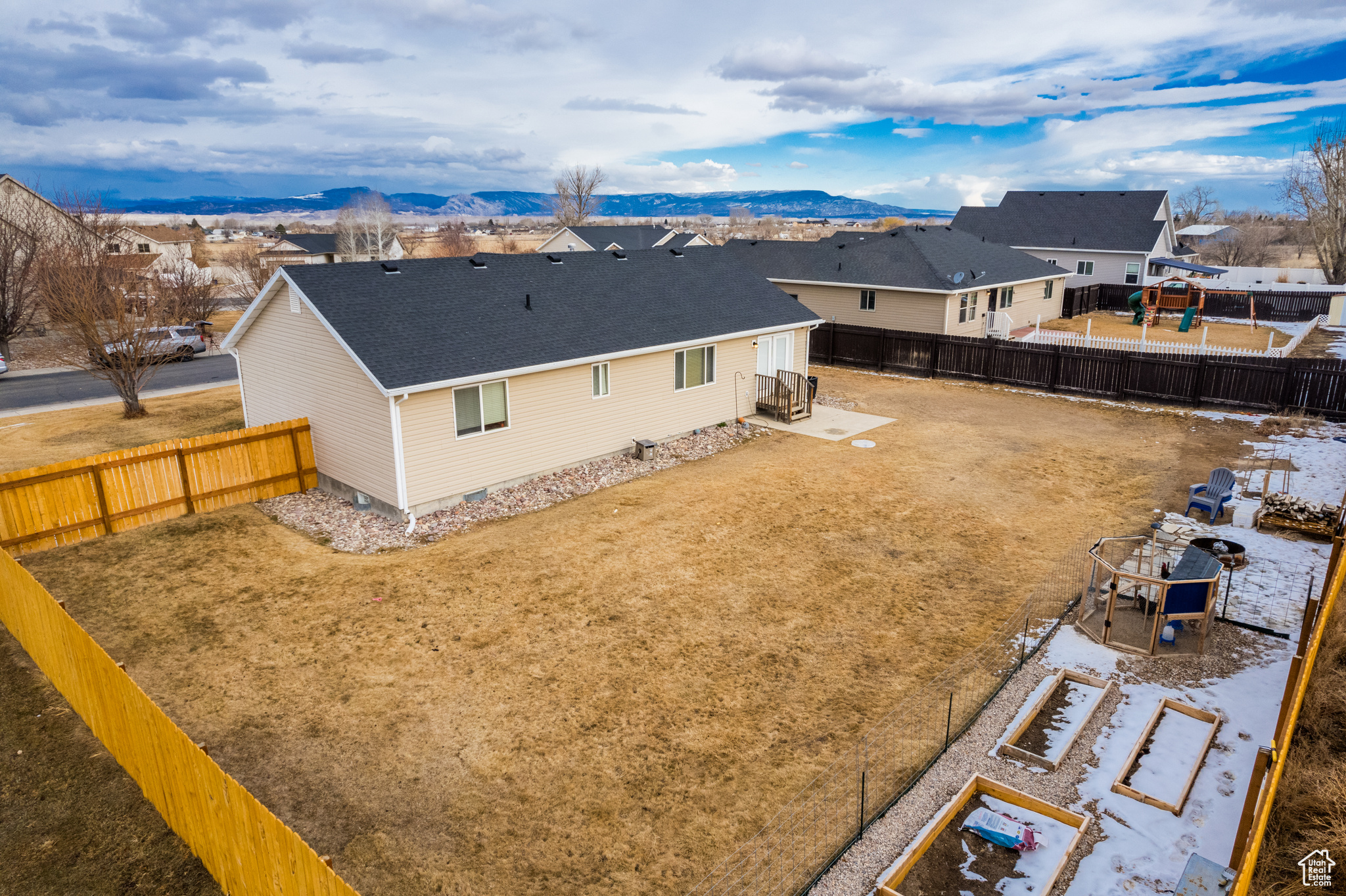 Rear view of property featuring central air condition unit and a mountain view