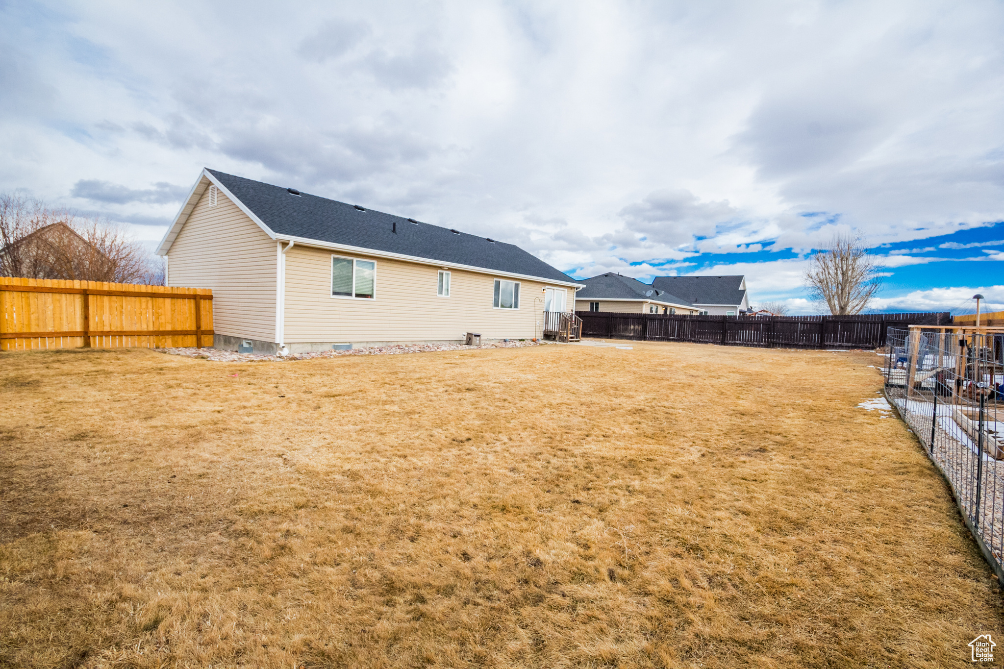 Back of property with a lawn