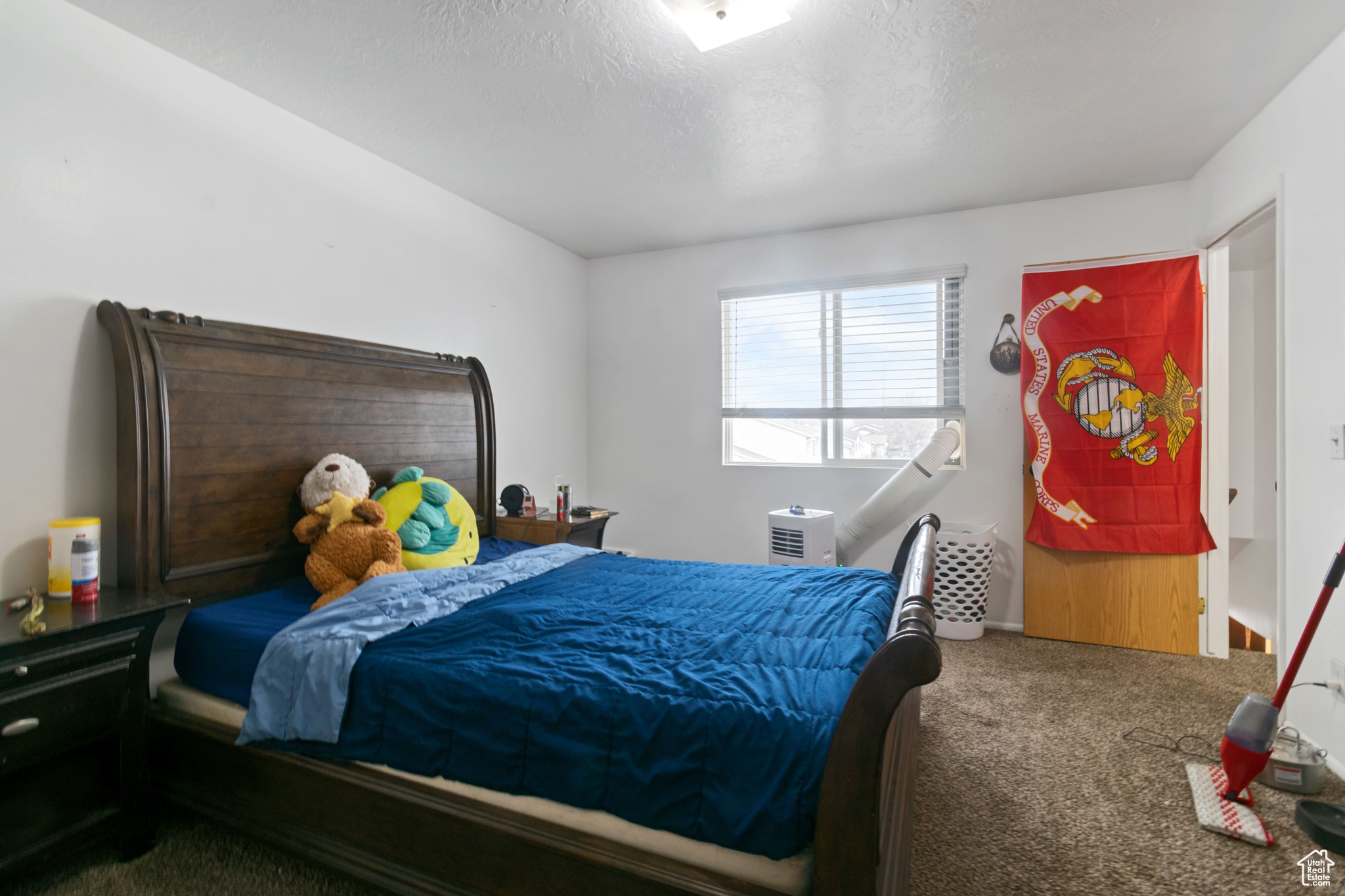 Carpeted bedroom with a textured ceiling