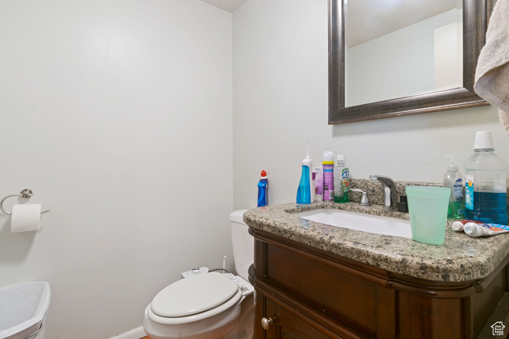 Bathroom with baseboards, vanity, and toilet