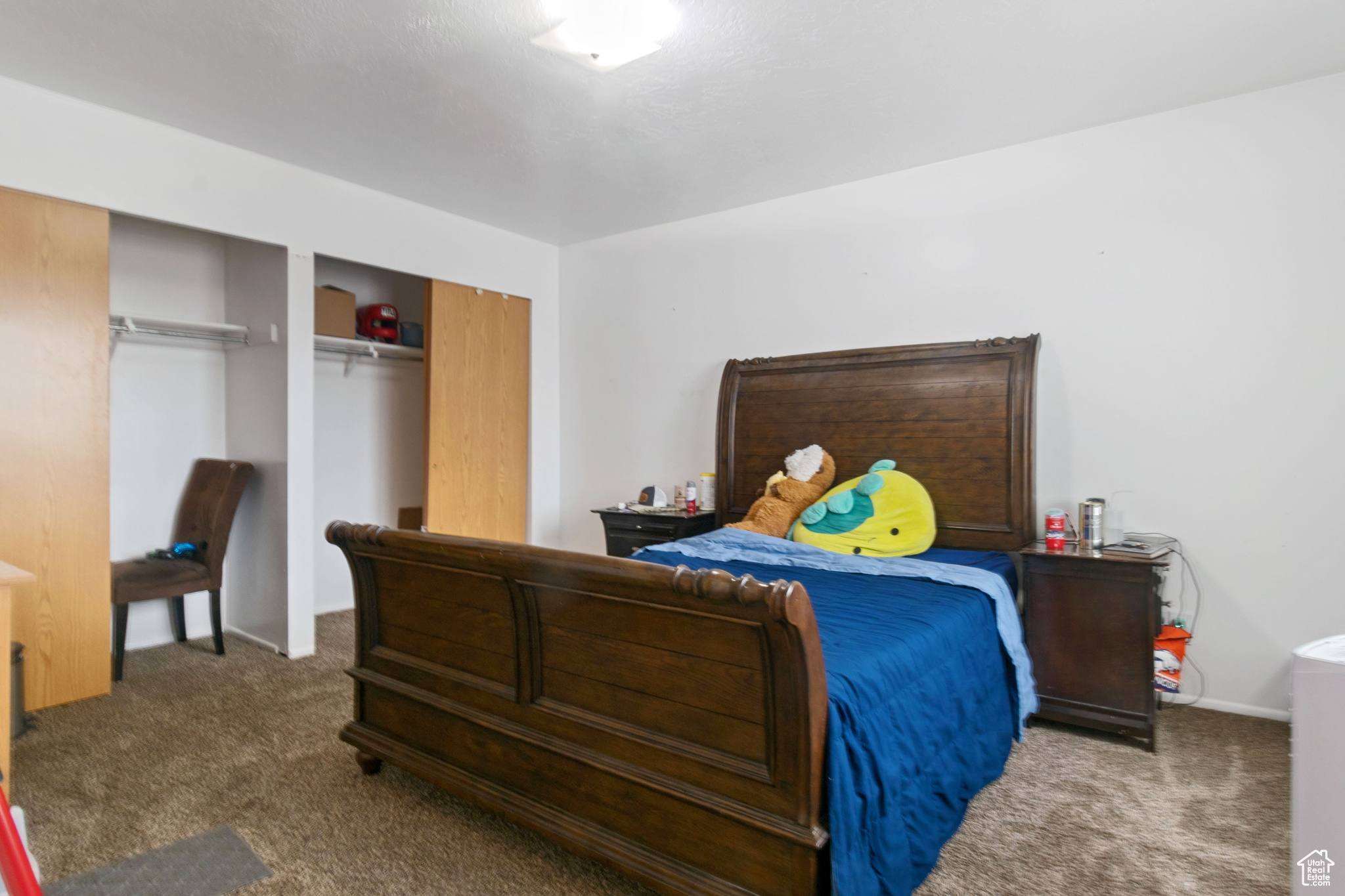 Carpeted bedroom featuring two closets