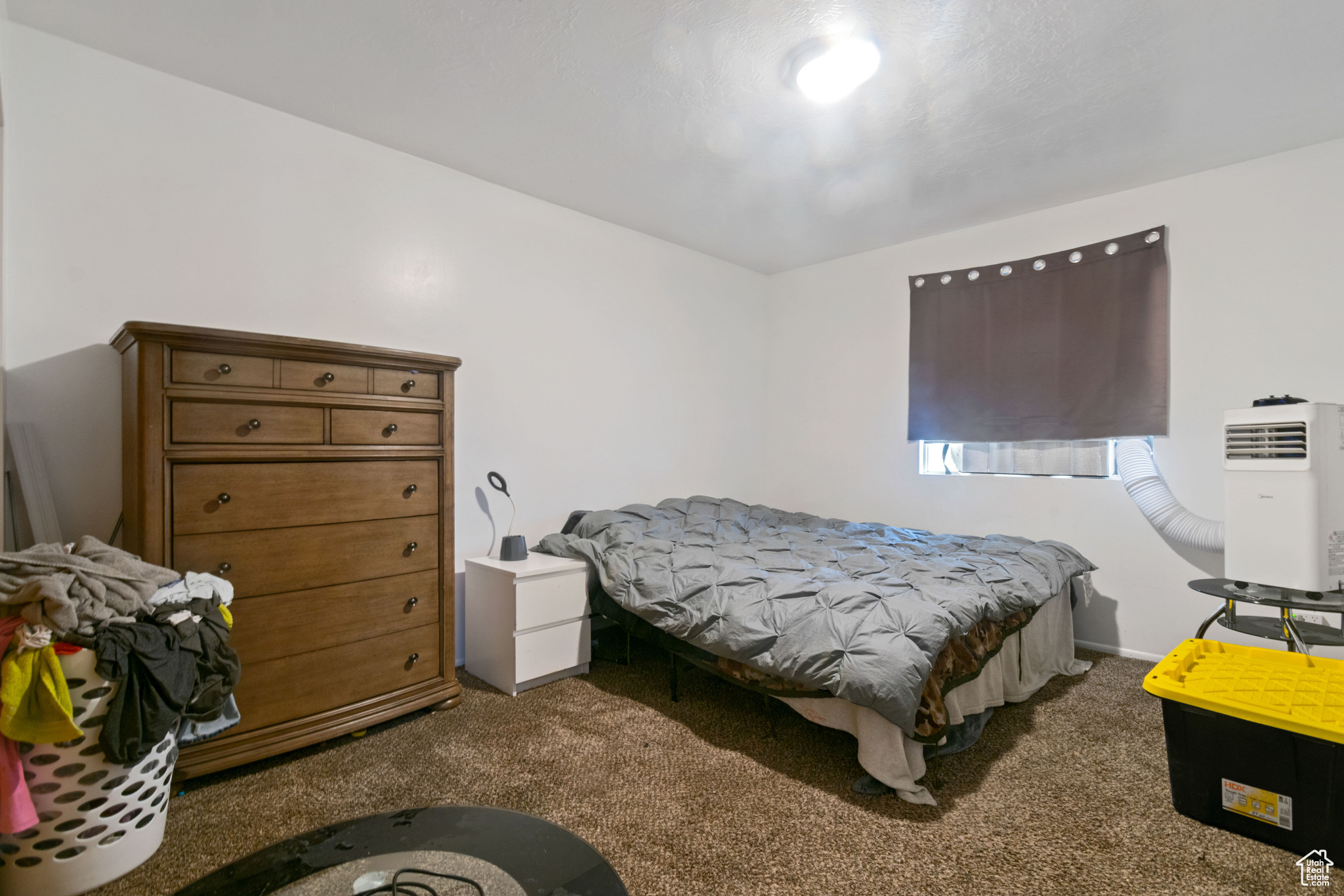 Bedroom with dark colored carpet
