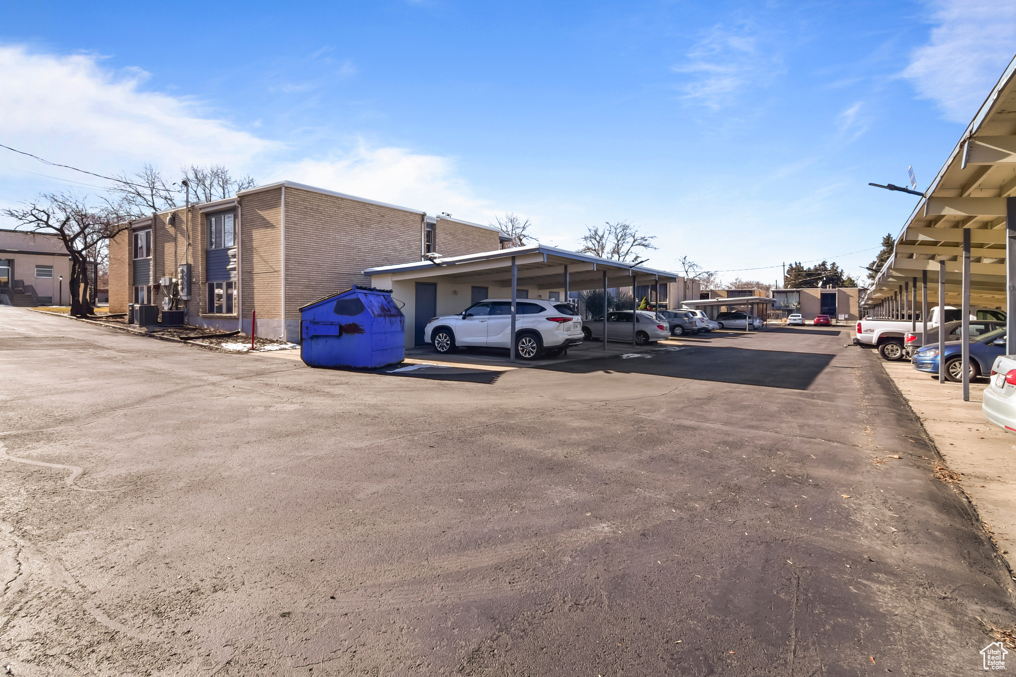 Partially covered parking lot with a residential view