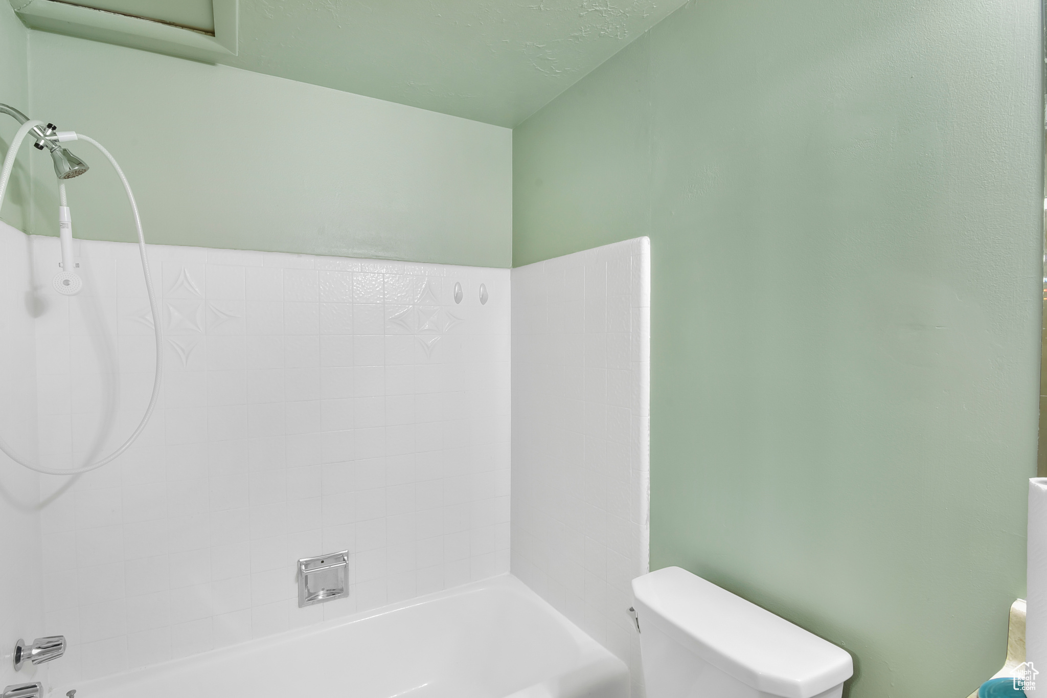 Bathroom with shower / bathing tub combination and toilet