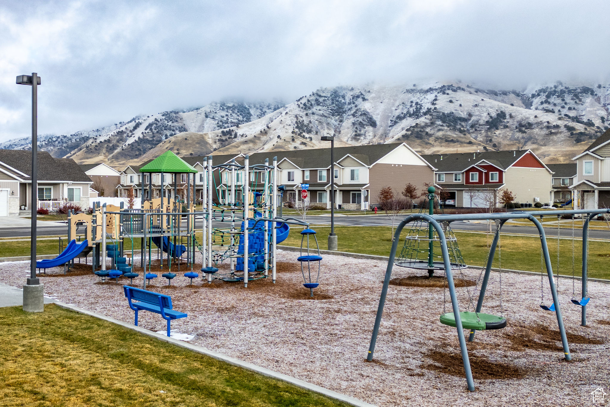 Community playground with a residential view and a mountain view