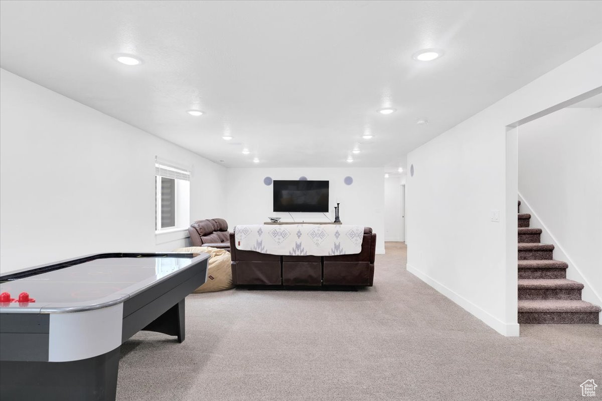 Rec room with light carpet, recessed lighting, and baseboards