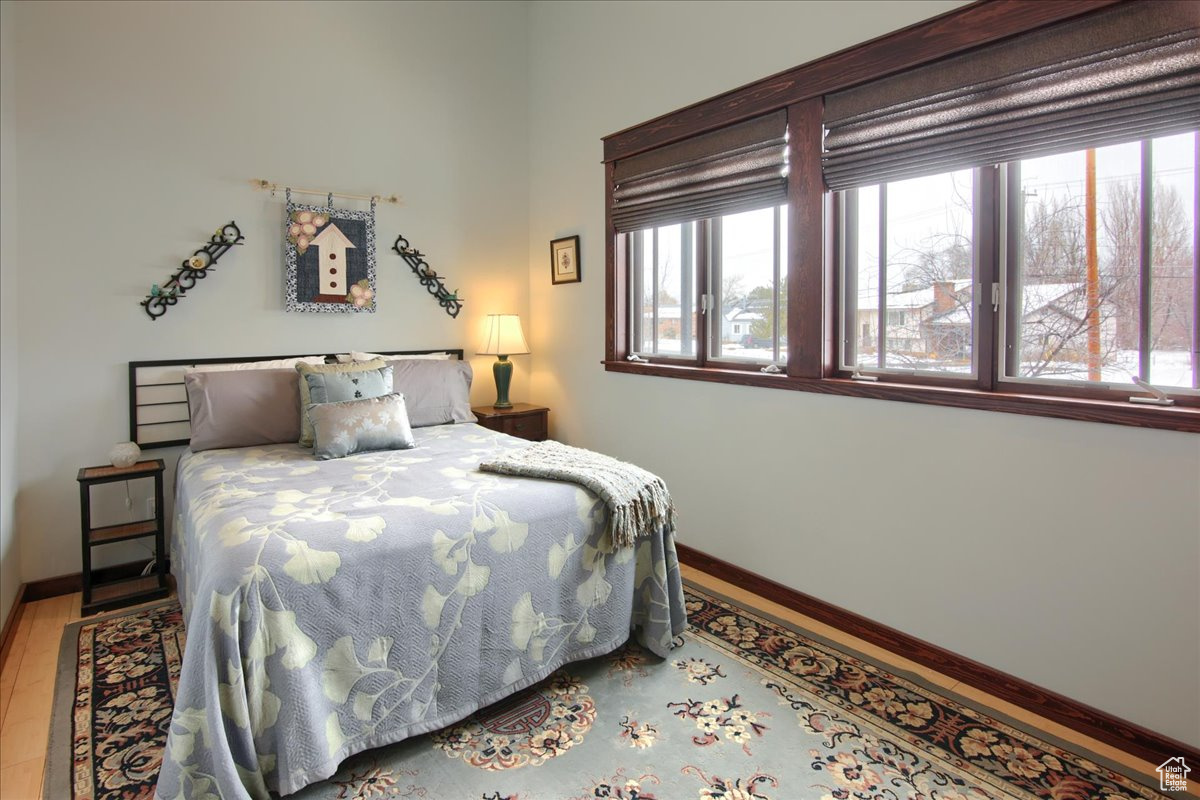 Bedroom featuring multiple windows and baseboards